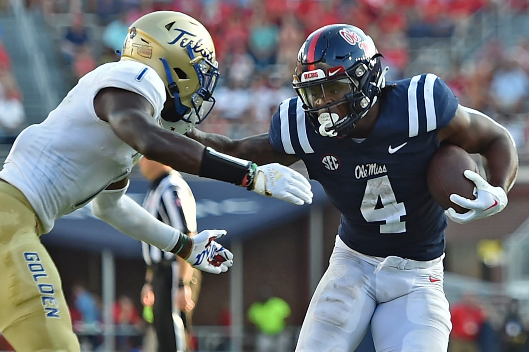 OXFORD, MISSISSIPPI - SEPTEMBER 24: Quinshon Judkins #4 of the Mississippi Rebels carrie the ball against Kendarin Ray #1 of the Tulsa Golden Hurricane during the game at Vaught-Hemingway Stadium on September 24, 2022 in Oxford, Mississippi. (Photo by Justin Ford/Getty Images)
