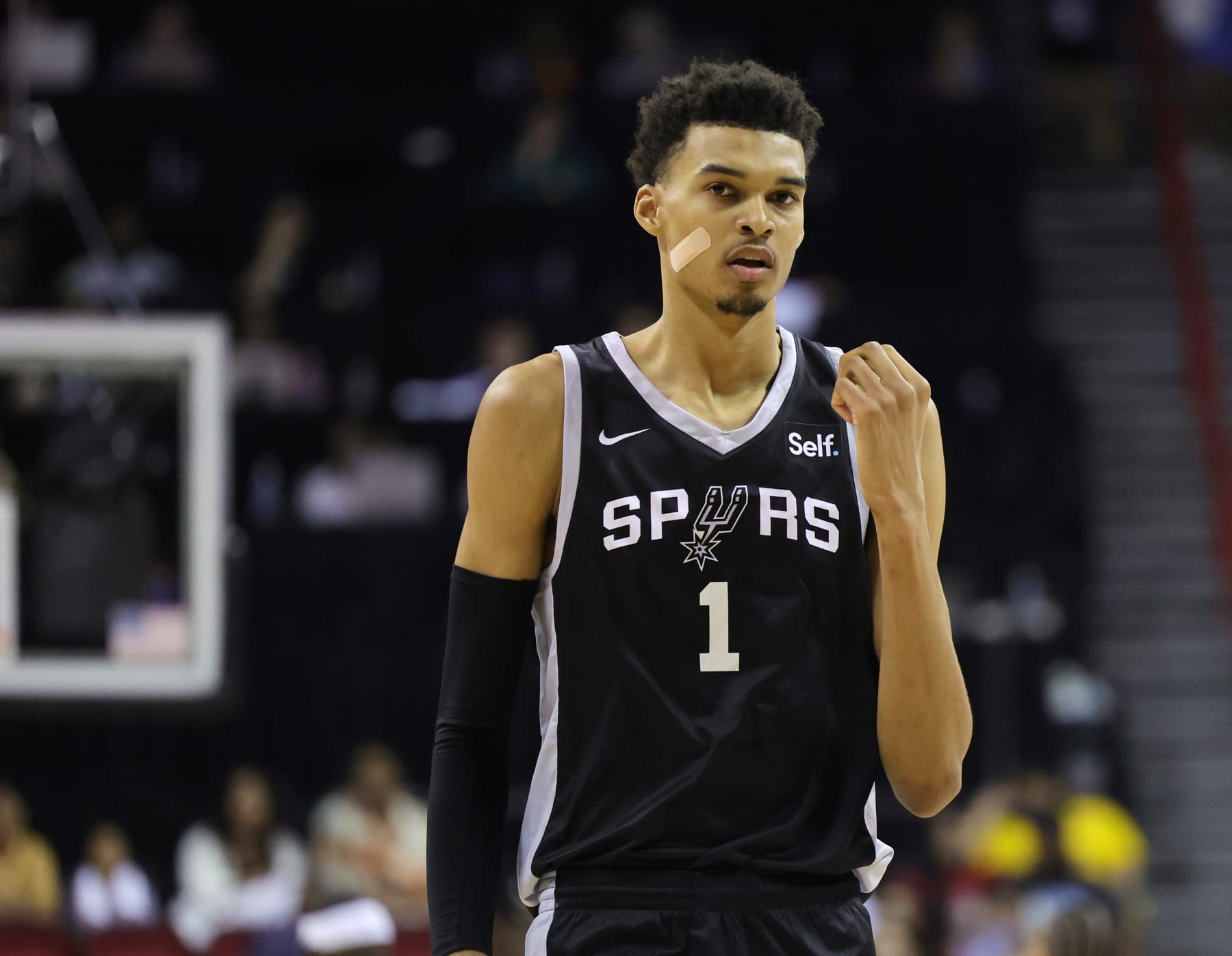 LAS VEGAS, NEVADA - JULY 09: Victor Wembanyama #1 of the San Antonio Spurs wears a bandage on his face as he walks on the court during a break in the second half of a 2023 NBA Summer League game against the Portland Trail Blazers at the Thomas & Mack Center on July 09, 2023 in Las Vegas, Nevada. NOTE TO USER: User expressly acknowledges and agrees that, by downloading and or using this photograph, User is consenting to the terms and conditions of the Getty Images License Agreement. (Photo by Ethan Miller/Getty Images)