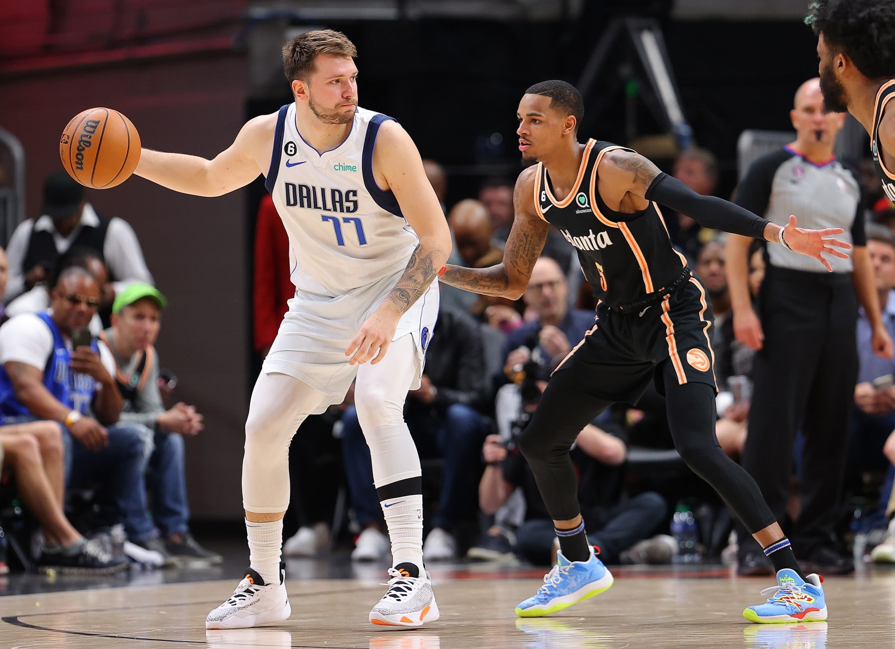 ATLANTA, GEORGIA - APRIL 02:  Luka Doncic #77 of the Dallas Mavericks is defended by Dejounte Murray #5 of the Atlanta Hawks during the third quarter at State Farm Arena on April 02, 2023 in Atlanta, Georgia.  NOTE TO USER: User expressly acknowledges and agrees that, by downloading and or using this photograph, User is consenting to the terms and conditions of the Getty Images License Agreement.  (Photo by Kevin C. Cox/Getty Images)