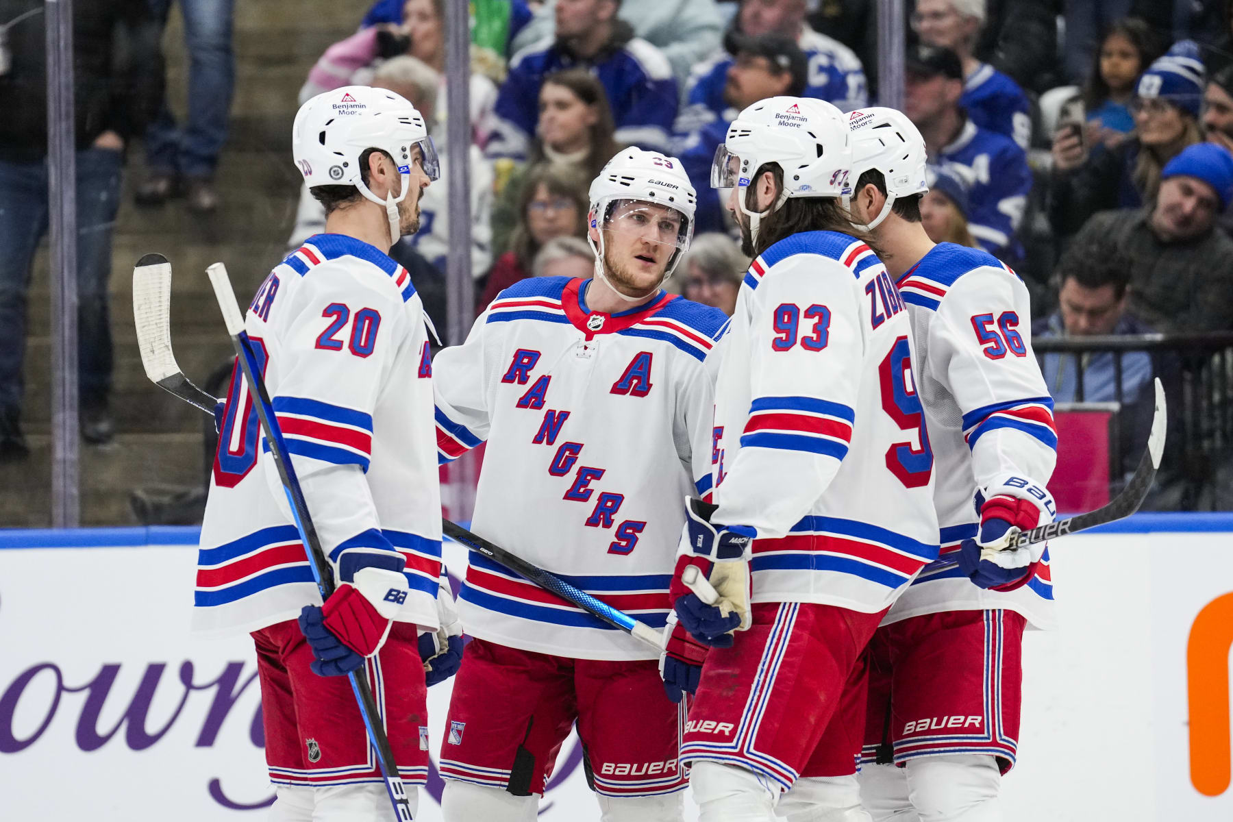 TORONTO, ON - MARCH 2: Adam Fox #23 of the New York Rangers talks with teammates Chris Kreider #20, Mika Zibanejad #93 and Erik Gustafsson #56 during the first period against the Toronto Maple Leafs at Scotiabank Arena on March 2, 2024 in Toronto, Ontario, Canada. (Photo by Andrew Lahodynskyj/NHLI via Getty Images)