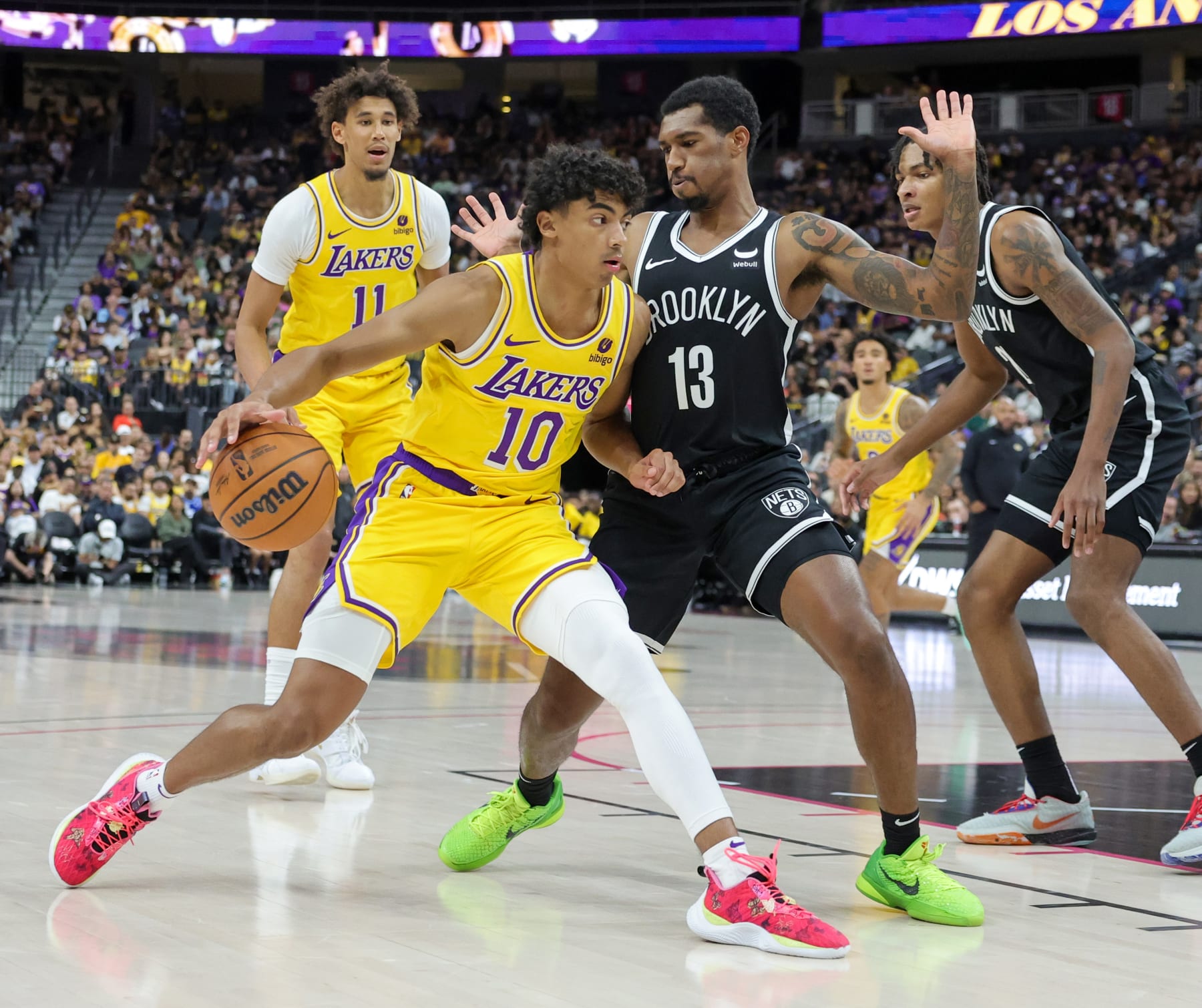 LAS VEGAS, NEVADA - OCTOBER 09: Max Christie #10 of the Los Angeles Lakers drives against Armoni Brooks #13 of the Brooklyn Nets in the fourth quarter of their preseason game at T-Mobile Arena on October 09, 2023 in Las Vegas, Nevada. The Lakers defeated the Nets 129-126. NOTE TO USER: User expressly acknowledges and agrees that, by downloading and or using this photograph, User is consenting to the terms and conditions of the Getty Images License Agreement. (Photo by Ethan Miller/Getty Images)