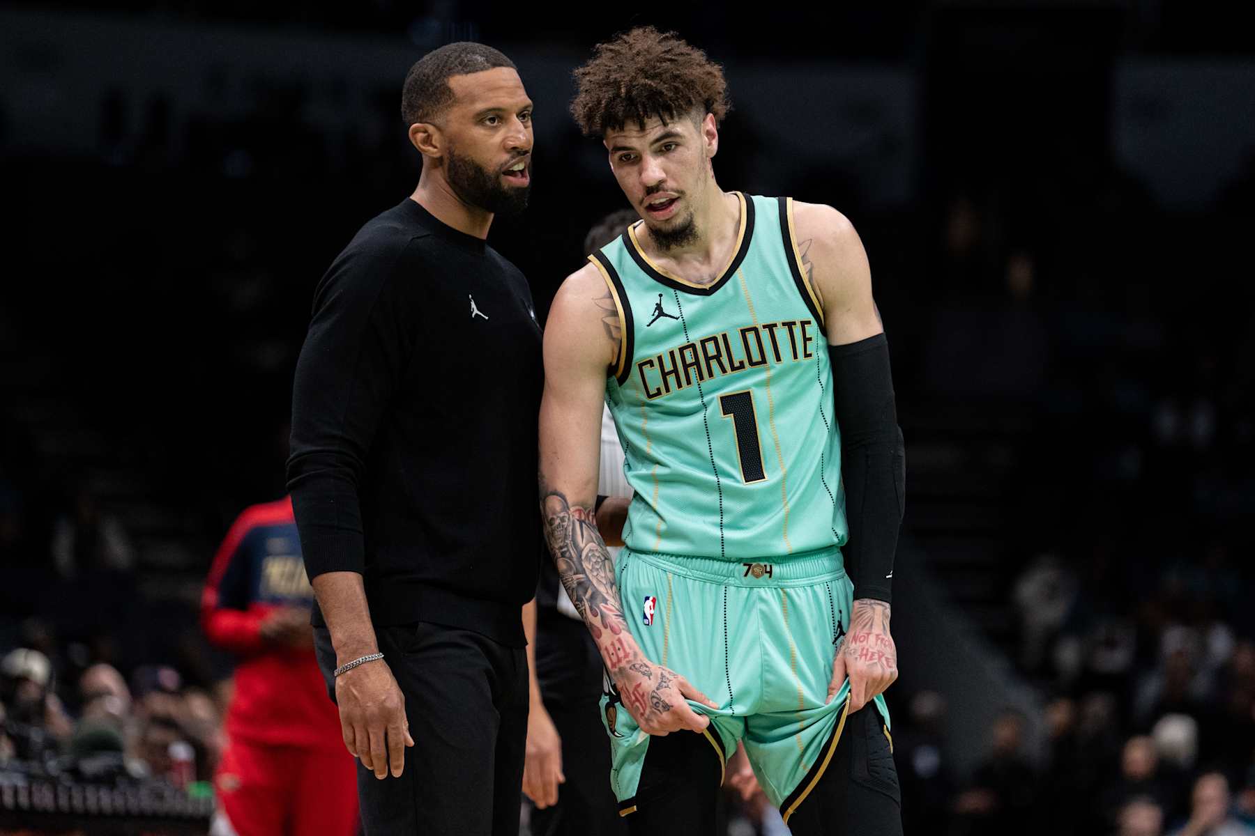 CHARLOTTE, NORTH CAROLINA - JANUARY 25: Head coach Charles Lee of the Charlotte Hornets talks to LaMelo Ball #1 in the first quarter during their game against the New Orleans Pelicans at Spectrum Center on January 25, 2025 in Charlotte, North Carolina. NOTE TO USER: User expressly acknowledges and agrees that, by downloading and or using this photograph, User is consenting to the terms and conditions of the Getty Images License Agreement. (Photo by Jacob Kupferman/Getty Images)