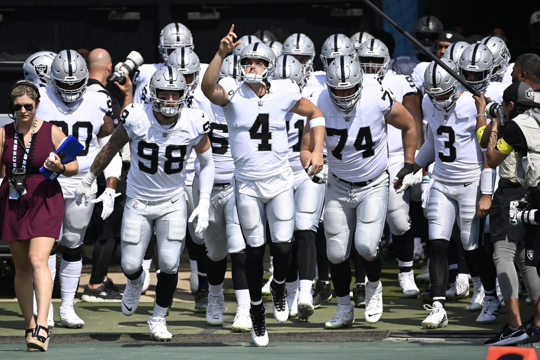 Las Vegas Raiders quarterback Derek Carr (4) leads his team onto the field for the first half of an NFL football game against the Tennessee Titans Sunday, Sept. 25, 2022, in Nashville, Tenn. (AP Photo/Mark Zaleski)