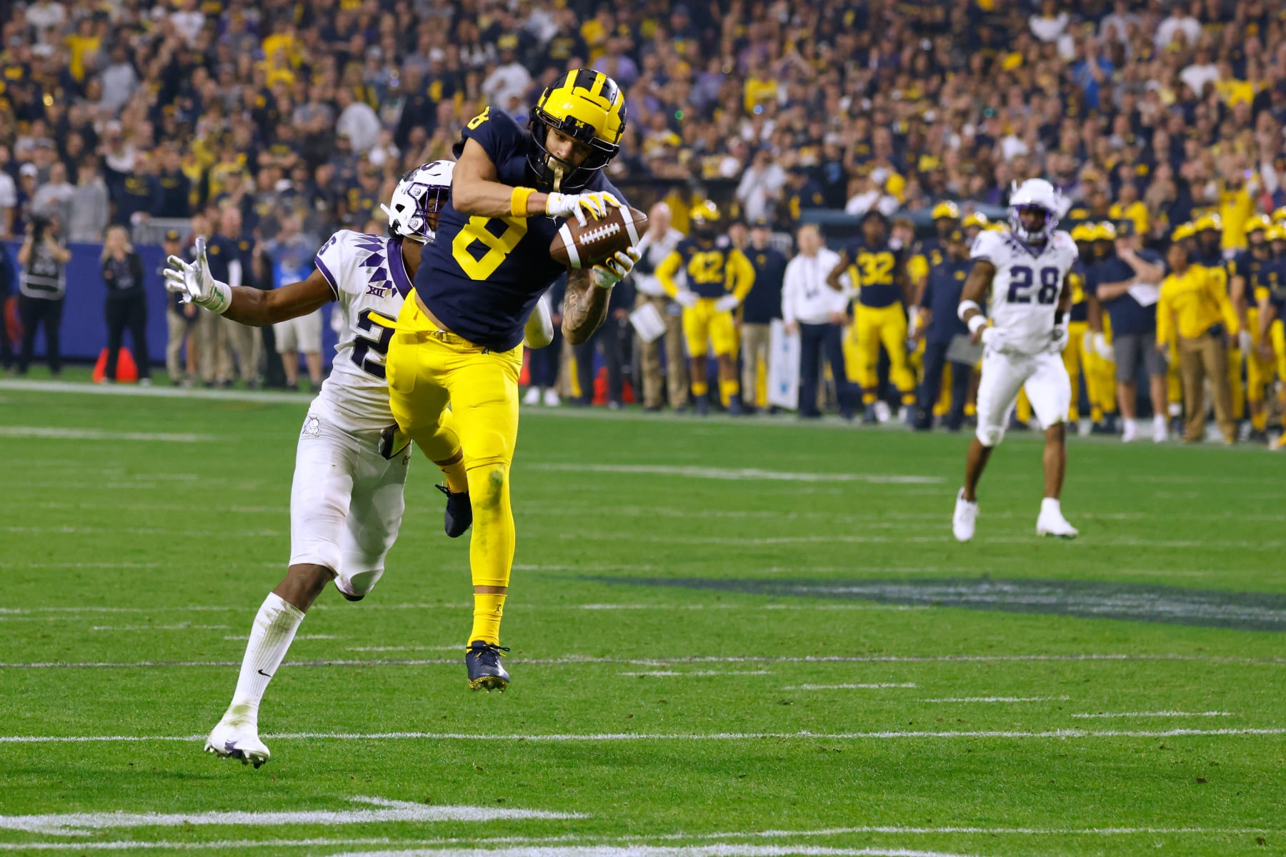 GLENDALE, AZ - DECEMBER 31: Ronnie Bell #8 of the Michigan Wolverines makes a catch against Bud Clark #26 of the TCU Horned Frogs during the second half of the Vrbo Fiesta Bowl at State Farm Stadium on December 31, 2022 in Glendale, Arizona. (Photo by Lance King/Getty Images)