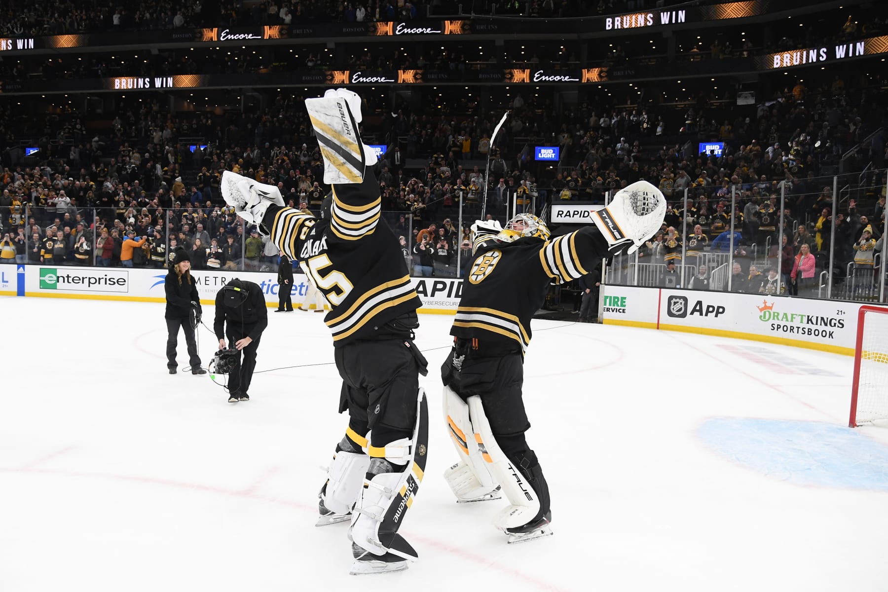 BOSTON, MASSACHUSETTS - JANUARY 18: Linus Ullmark #35 and Jeremy Swayman #1 of the Boston Bruins celebrate the win against the Colorado Avalanche at the TD Garden on January 18, 2024 in Boston, Massachusetts. (Photo by Steve Babineau/NHLI via Getty Images)