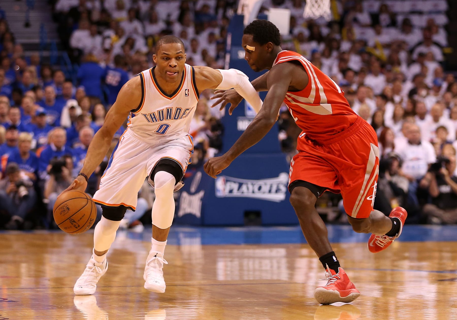 OKLAHOMA CITY, OK - APRIL 24:  Russell Westbrook #0 of the Oklahoma City Thunder drives the ball past Patrick Beverley #12 of the Houston Rockets during the first quarter of Game Two of the Western Conference Quarterfinals of the 2013 NBA Playoffs at Chesapeake Energy Arena on April 24, 2013 in Oklahoma City, Oklahoma. NOTE TO USER: User expressly acknowledges and agrees that, by downloading and or using this photograph, User is consenting to the terms and conditions of the Getty Images License Agreement.  (Photo by Christian Petersen/Getty Images)