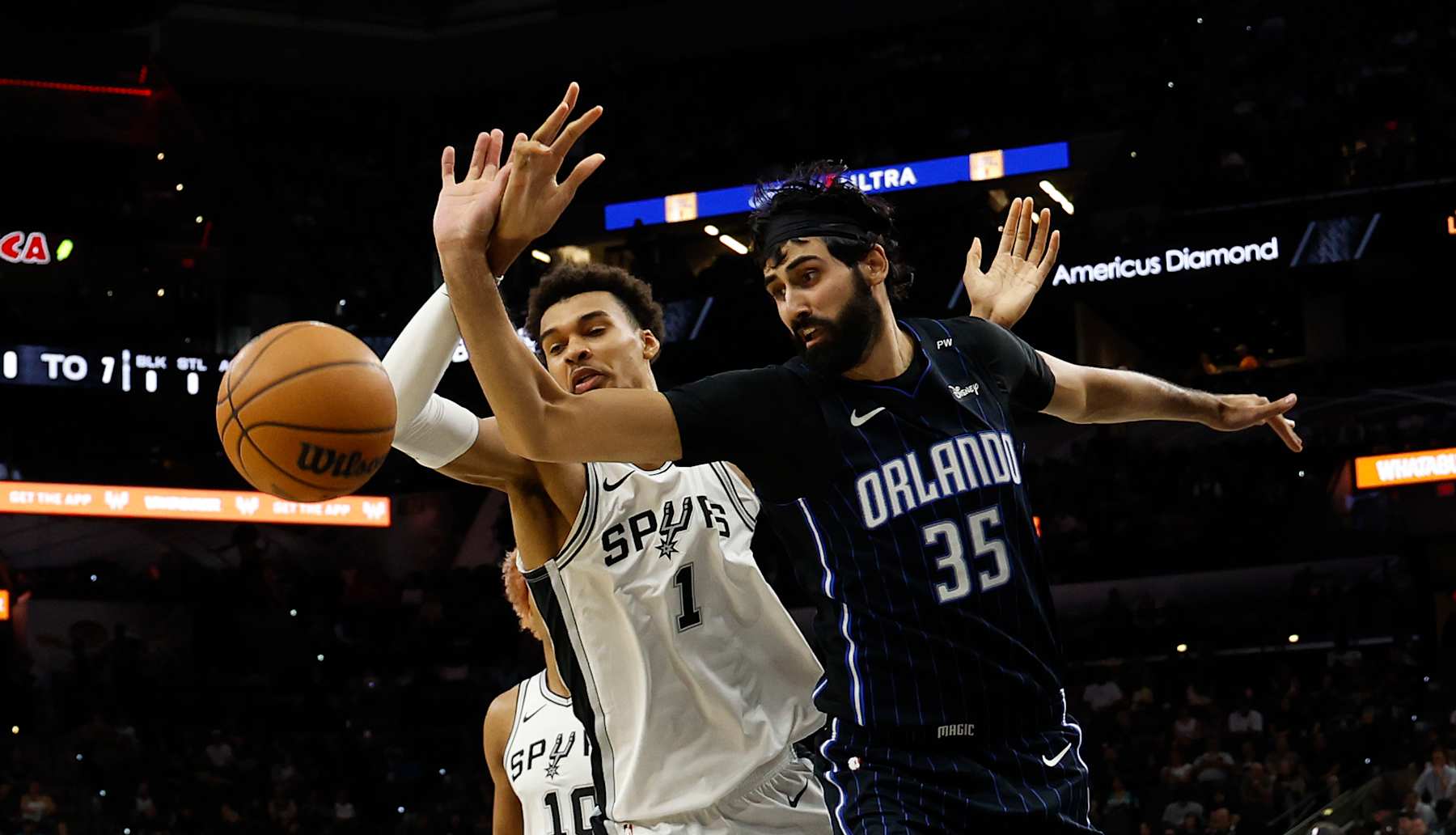 SAN ANTONIO, TX - OCTOBER 09: Victor Wembanyama #1 of the San Antonio Spurs battles Goga Bitadze #35 of the Orlando Magic for a loose ball in the first half of a preseason game at Frost Bank Center on October 9, 2024 in San Antonio, Texas. NOTE TO USER: User expressly acknowledges and agrees that, by downloading and or using this photograph, User is consenting to terms and conditions of the Getty Images License Agreement. (Photo by Ronald Cortes/Getty Images)