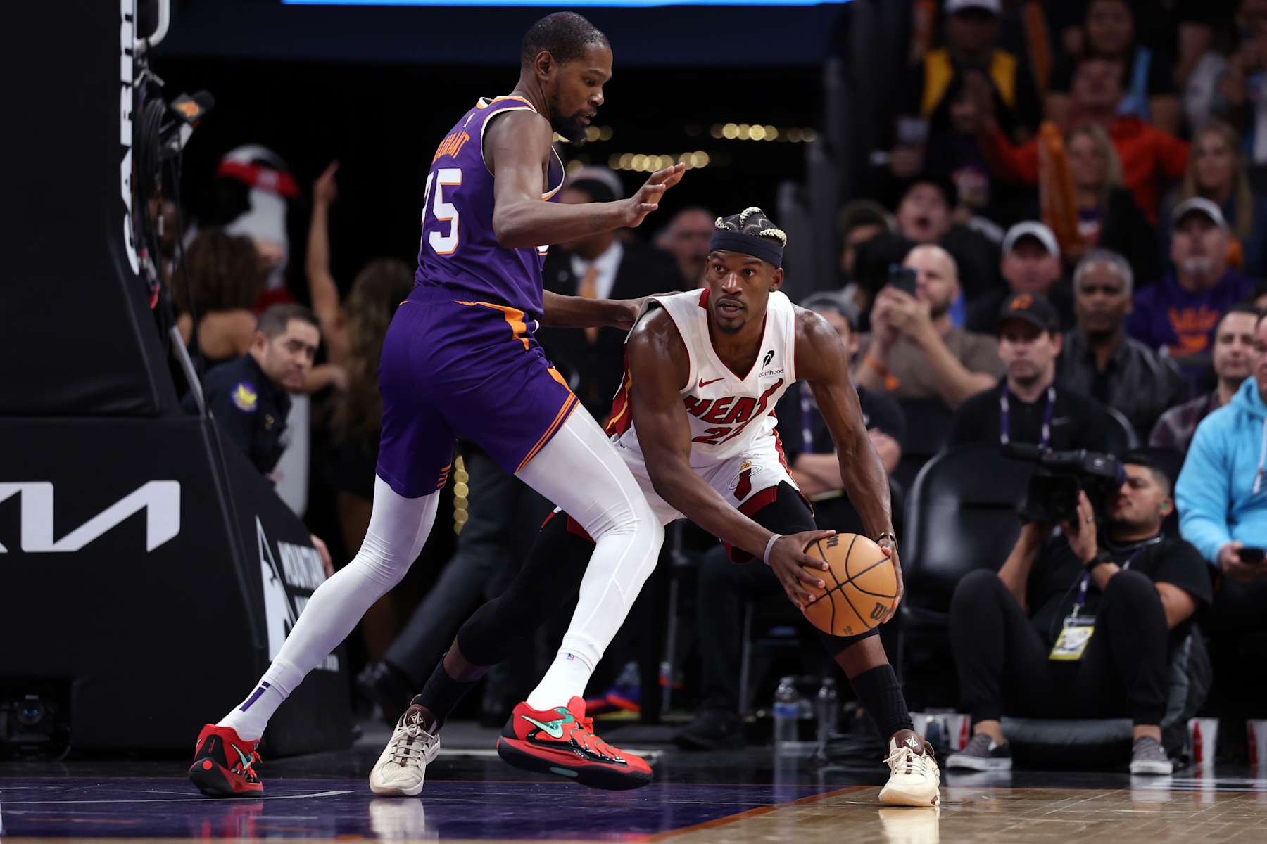 PHOENIX, ARIZONA - NOVEMBER 06: Jimmy Butler #22 of the Miami Heat controls the ball under pressure from Kevin Durant #35 of the Phoenix Suns during the game at Footprint Center on November 06, 2024 in Phoenix, Arizona. The Suns defeated the Heat 115-112. NOTE TO USER: User expressly acknowledges and agrees that, by downloading and or using this photograph, User is consenting to the terms and conditions of the Getty Images License Agreement.  (Photo by Chris Coduto/Getty Images)