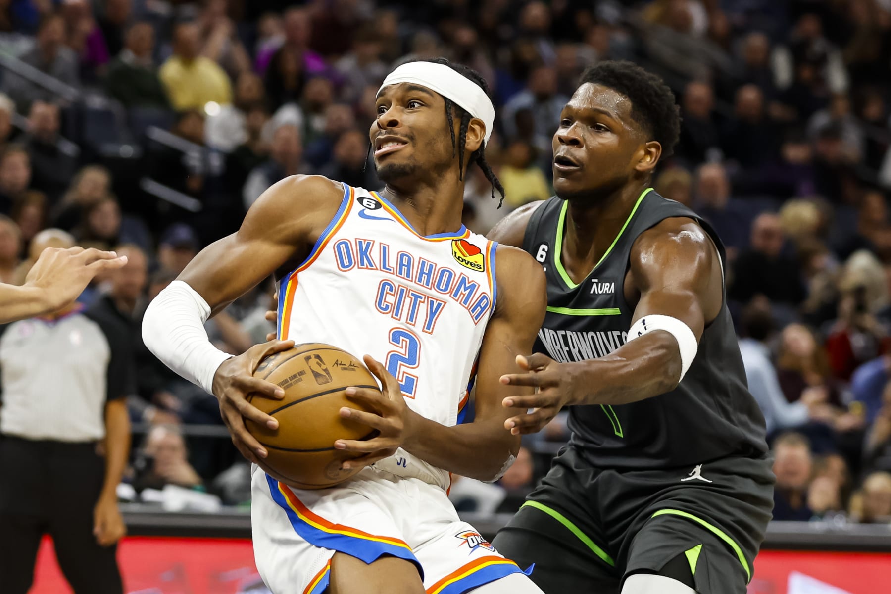 MINNEAPOLIS, MN - DECEMBER 03: Shai Gilgeous-Alexander #2 of the Oklahoma City Thunder in action while Anthony Edwards #1 of the Minnesota Timberwolves defends in the third quarter of the game at Target Center on December 3, 2022 in Minneapolis, Minnesota. The Thunder defeated the Timberwolves 135-128. NOTE TO USER: User expressly acknowledges and agrees that, by downloading and or using this Photograph, user is consenting to the terms and conditions of the Getty Images License Agreement. (Photo by David Berding/Getty Images)