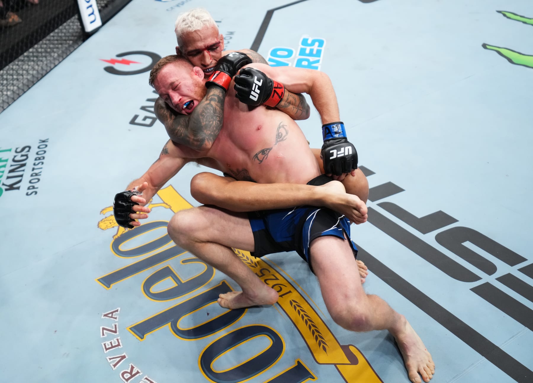 PHOENIX, ARIZONA - MAY 07: (R-L) Charles Oliveira of Brazil secures a rear choke submission against Justin Gaethje in the UFC lightweight championship fight during the UFC 274 event at Footprint Center on May 07, 2022 in Phoenix, Arizona. (Photo by Chris Unger/Zuffa LLC)