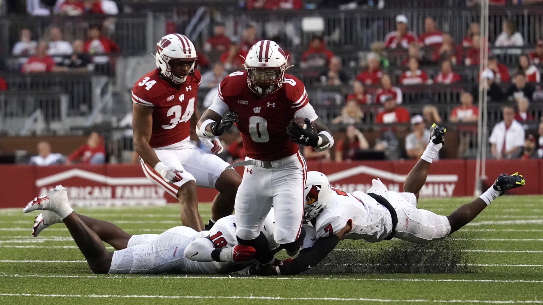 Wisconsin's Braelon Allen (0) runs between Illinois State's Jeremiah Jordan (18) and Franky West (7) during the first half of an NCAA college football game Saturday, Sept. 3, 2022 in Madison, Wis. (AP Photo/Aaron Gash)