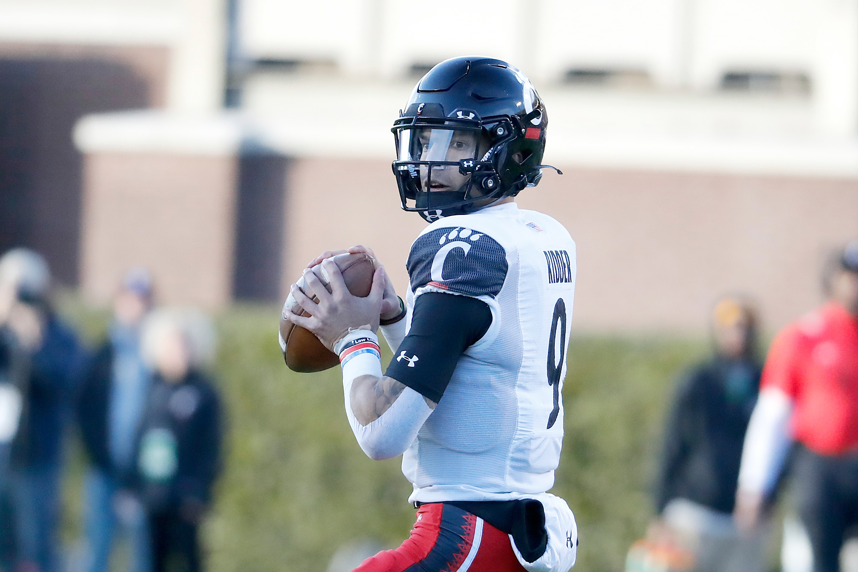 Cincinnati quarterback Desmond Ridder (9) prepares to throw the ball against East Carolina during the first half of an NCAA college football game in Greenville, N.C., Friday, Nov. 26, 2021. (AP Photo/Karl B DeBlaker)