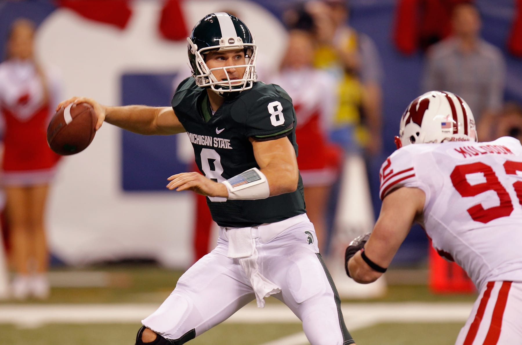 INDIANAPOLIS, IN - DECEMBER 03:  Kirk Cousins #8 of the Michigan State Spartans looks to pass under pressure from Pat Muldoon #92 of the Wisconsin Badgers during the Big 10 Conference Championship Game at Lucas Oil Stadium on December 3, 2011 in Indianapolis, Indiana.  (Photo by Gregory Shamus/Getty Images)