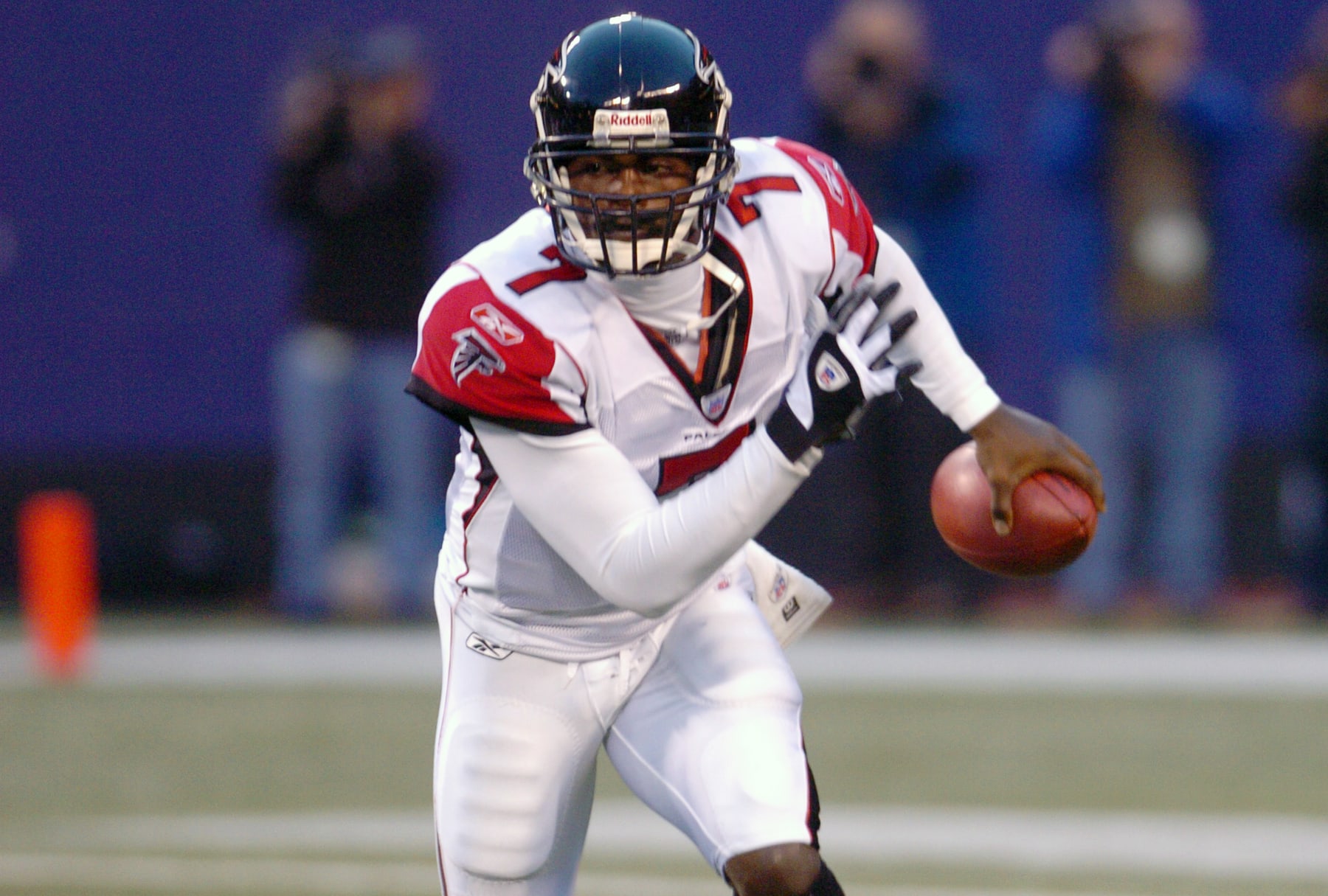 EAST RUTHERFORD, NJ - NOVEMBER 21:  Michael Vick #7 of the Atlanta Falcons runs with the ball against the New York Giants during an NFL football game November 21, 2004 at MetLife Stadium in East Rutherford, New Jersey. Vick played for the Falcons from 2001-2006. (Photo by Focus on Sport/Getty Images)