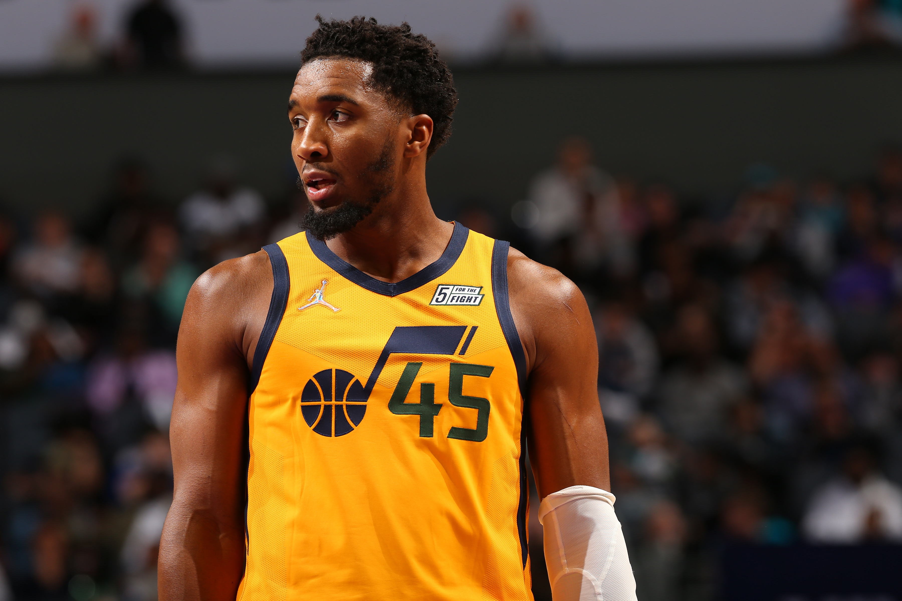 CHARLOTTE, NC - MARCH 25: Donovan Mitchell #45 of the Utah Jazz looks on during the game against the Charlotte Hornets on March 25, 2022 at Spectrum Center in Charlotte, North Carolina. NOTE TO USER: User expressly acknowledges and agrees that, by downloading and or using this photograph, User is consenting to the terms and conditions of the Getty Images License Agreement. Mandatory Copyright Notice: Copyright 2022 NBAE (Photo by Kent Smith/NBAE via Getty Images)