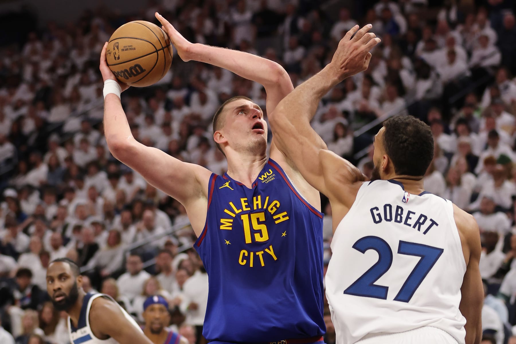 MINNEAPOLIS, MINNESOTA - APRIL 21: Nikola Jokic #15 of the Denver Nuggets takes a second half shot over Rudy Gobert #27 of the Minnesota Timberwolves during Game Three of the Western Conference First Round Playoffs at Target Center on April 21, 2023 in Minneapolis, Minnesota. Denver won the game 120-111 to take a 3-0 series lead. NOTE TO USER: User expressly acknowledges and agrees that, by downloading and or using this photograph, User is consenting to the terms and conditions of the Getty Images License Agreement. (Photo by Gregory Shamus/Getty Images)