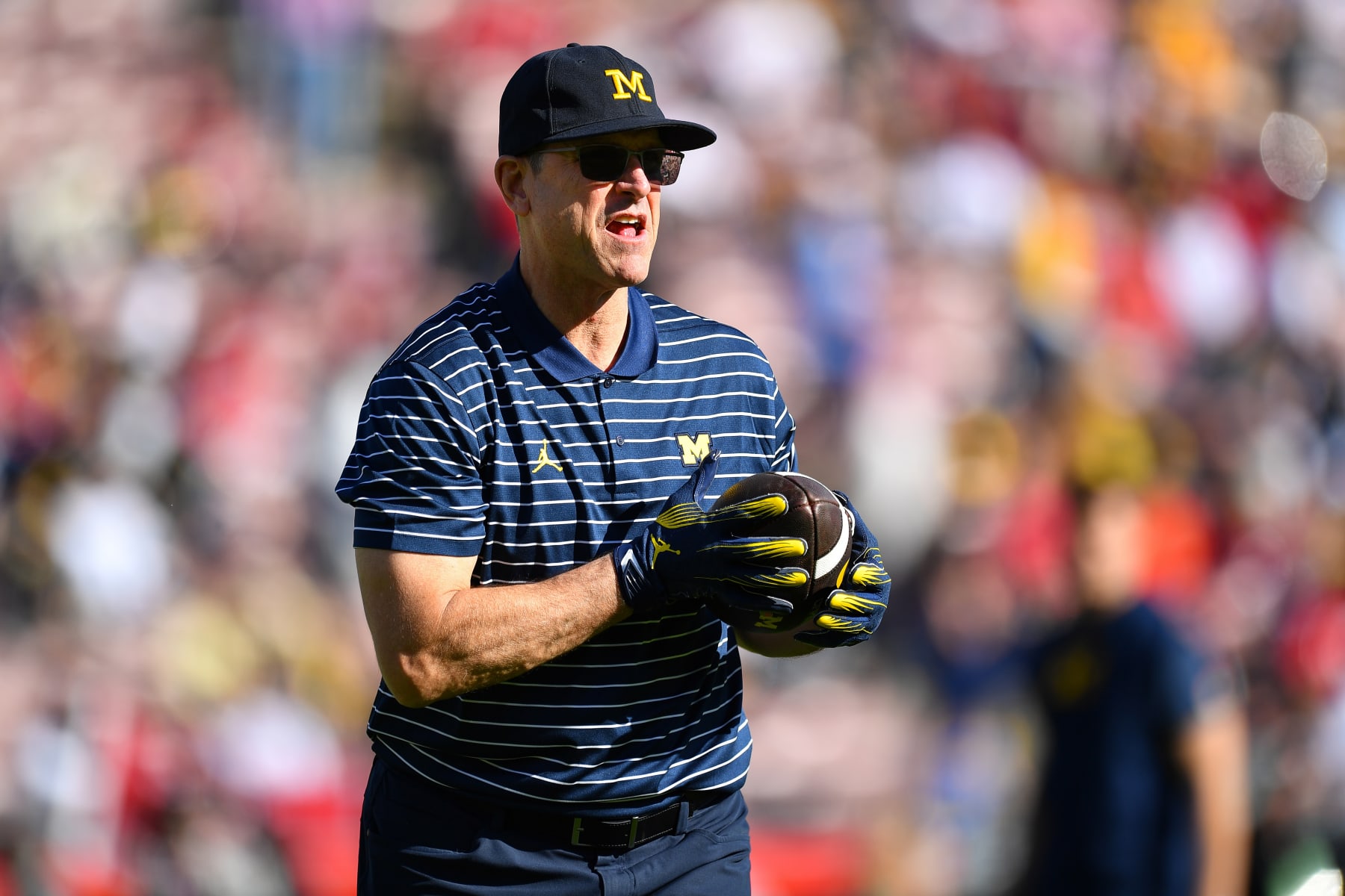 PASADENA, CA - JANUARY 01: Head Coach Jim Harbaugh of the Michigan Wolverines catches a pass before the Alabama Crimson Tide game versus the Michigan Wolverines CFP Semifinal at the Rose Bowl Game on January, 1, 2024, at the Rose Bowl Stadium in Pasadena, CA. (Photo by Brian Rothmuller/Icon Sportswire via Getty Images)
