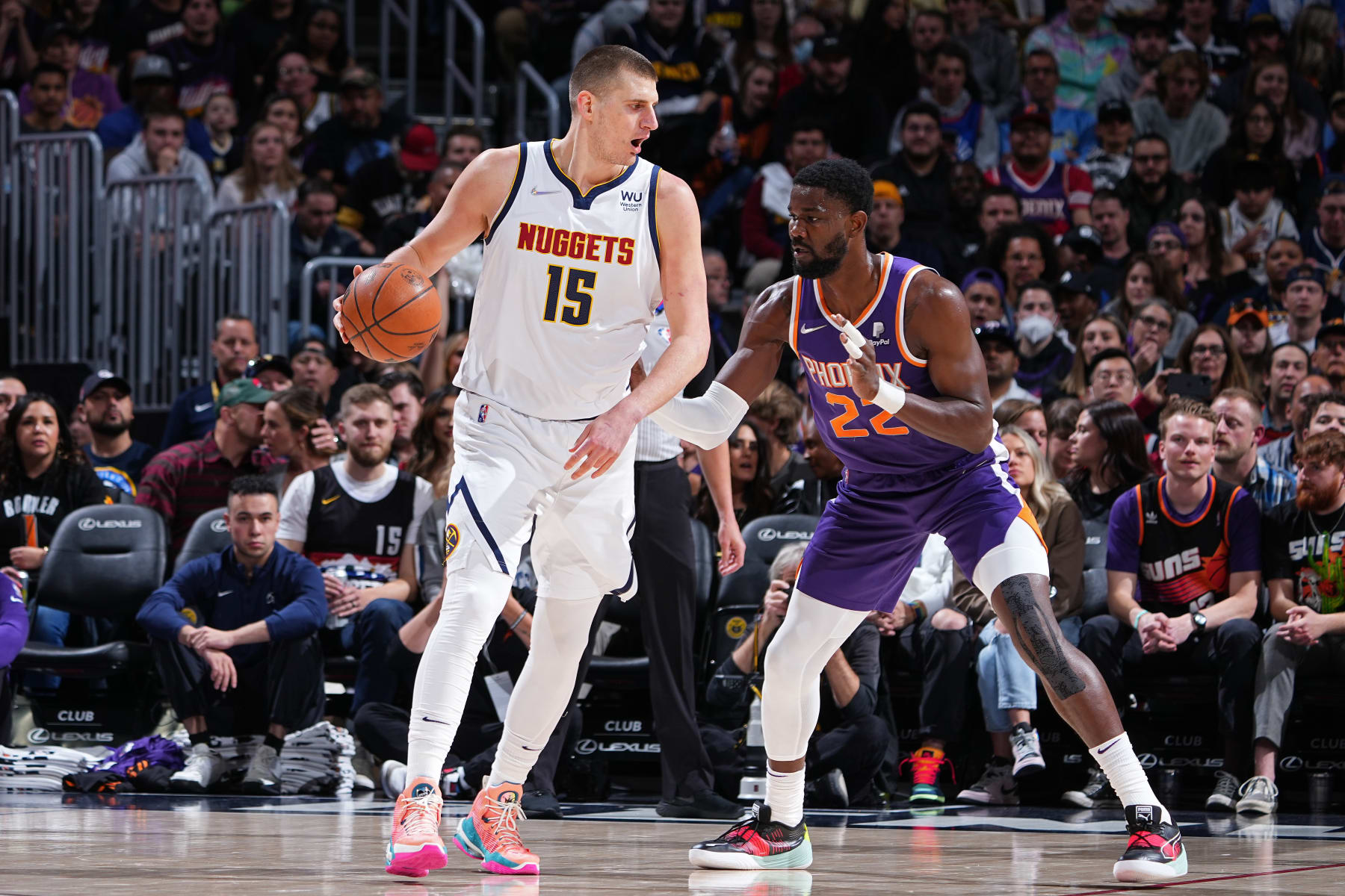 DENVER, CO - MARCH 24: Deandre Ayton #22 of the Phoenix Suns plays defense on Nikola Jokic #15 of the Denver Nuggets during the game on March 24, 2022 at the Ball Arena in Denver, Colorado. NOTE TO USER: User expressly acknowledges and agrees that, by downloading and/or using this Photograph, user is consenting to the terms and conditions of the Getty Images License Agreement. Mandatory Copyright Notice: Copyright 2022 NBAE (Photo by Garrett Ellwood/NBAE via Getty Images)
