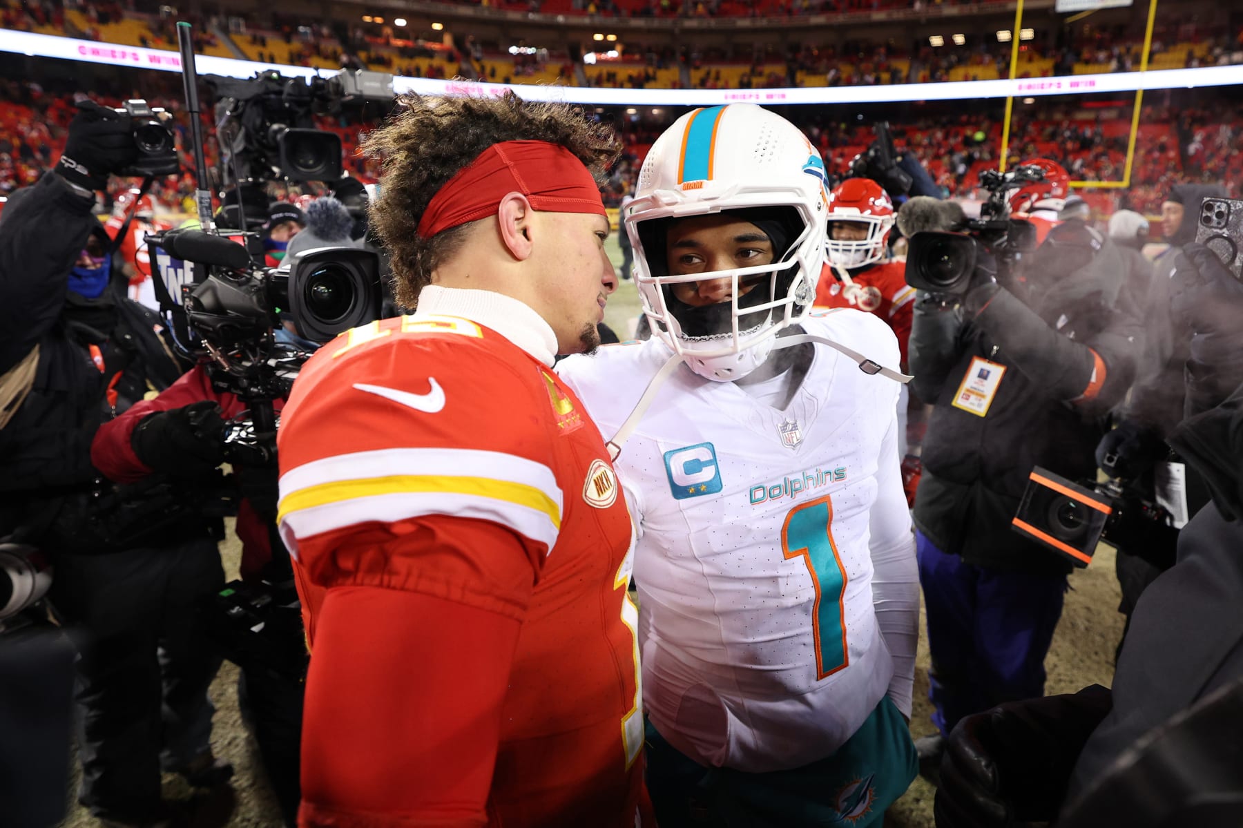 KANSAS CITY, MISSOURI - JANUARY 13: Patrick Mahomes #15 of the Kansas City Chiefs greets Tua Tagovailoa #1 of the Miami Dolphins after the Chiefs defeated the Dolphins 26-7 in the AFC Wild Card Playoffs at GEHA Field at Arrowhead Stadium on January 13, 2024 in Kansas City, Missouri. (Photo by Jamie Squire/Getty Images)