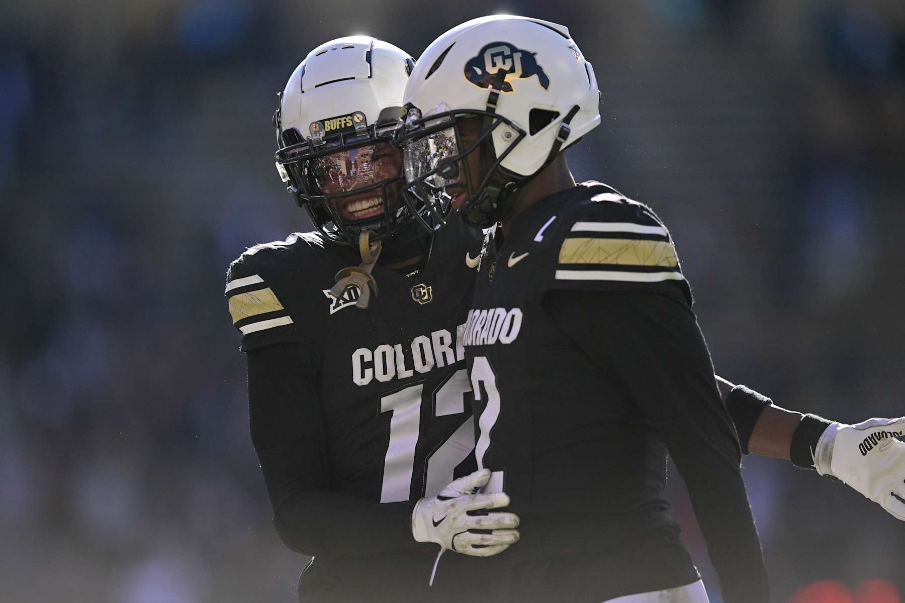 BOULDER, CO - NOVEMBER 29:  Shedeur Sanders #2 and Travis Hunter #12 of the Colorado Buffaloes celebrate after a third quarter touchdown against the Oklahoma State Cowboys at Folsom Field on November 29, 2024 in Boulder, Colorado. (Photo by Dustin Bradford/Getty Images)