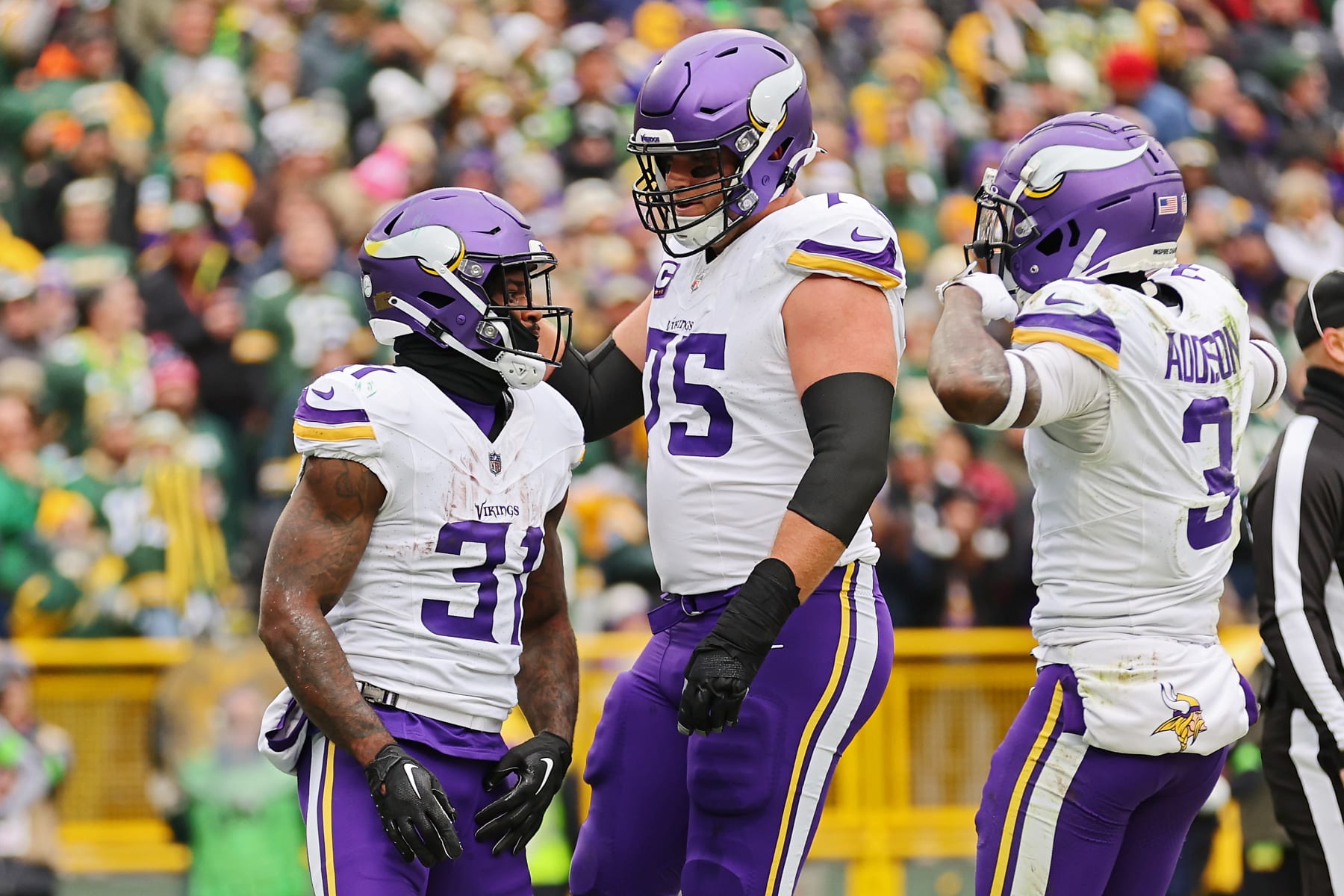 GREEN BAY, WISCONSIN - OCTOBER 29: Cam Akers #31 of the Minnesota Vikings celebrates with Brian O'Neill #75 of the Minnesota Vikings and Jordan Addison #3 of the Minnesota Vikings after a first quarter touchdown against the Green Bay Packers at Lambeau Field on October 29, 2023 in Green Bay, Wisconsin. (Photo by Michael Reaves/Getty Images)