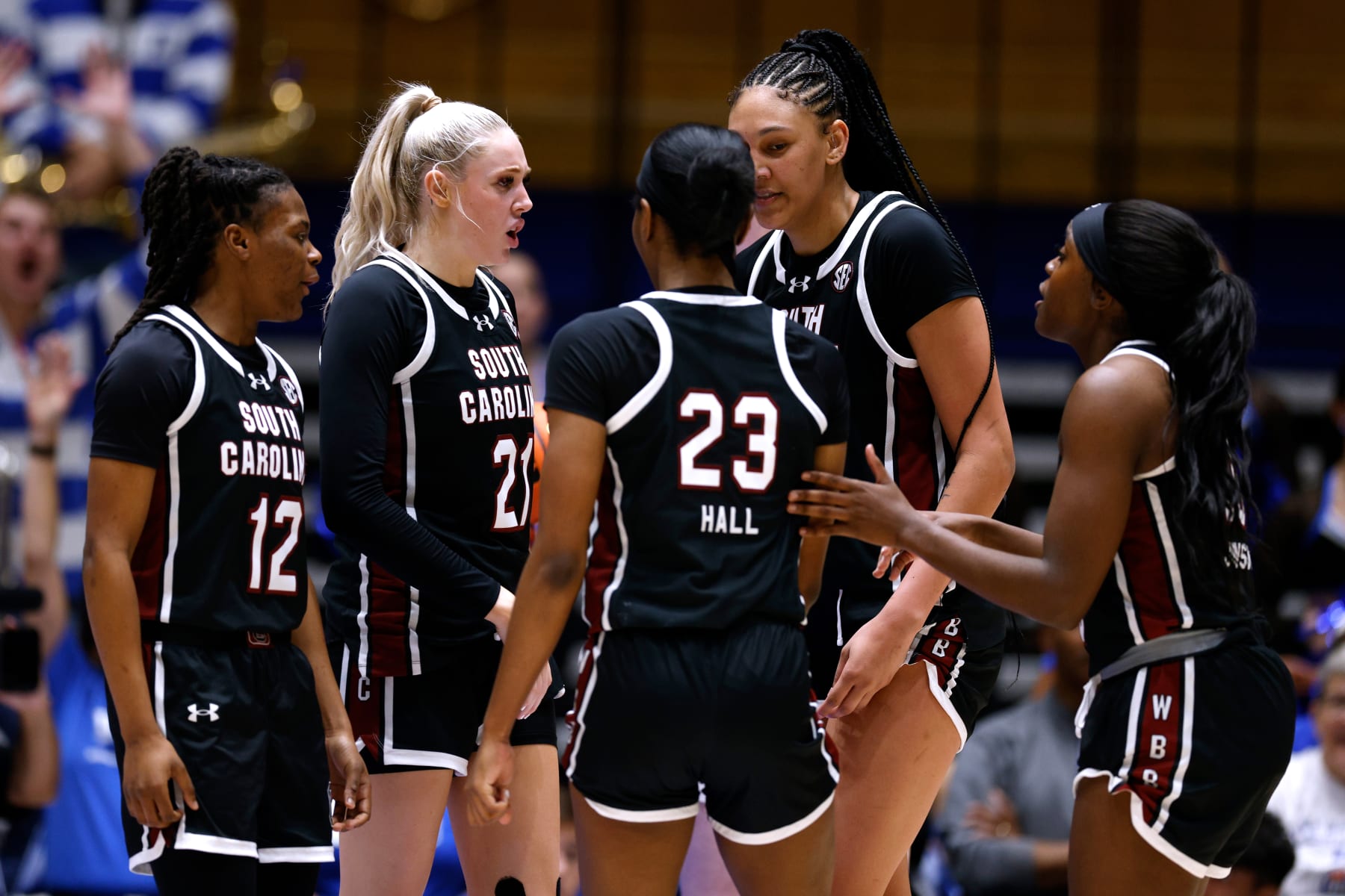 DURHAM, NORTH CAROLINA - DECEMBER 3: MiLaysia Fulwiley #12, Chloe Kitts #21, Bree Hall #23, Kamilla Cardoso #10 and Raven Johnson #25 of the South Carolina Gamecocks huddle during the game against the Duke Blue Devils at Cameron Indoor Stadium on December 3, 2023 in Durham, North Carolina. South Carolina won 77-61. (Photo by Lance King/Getty Images)