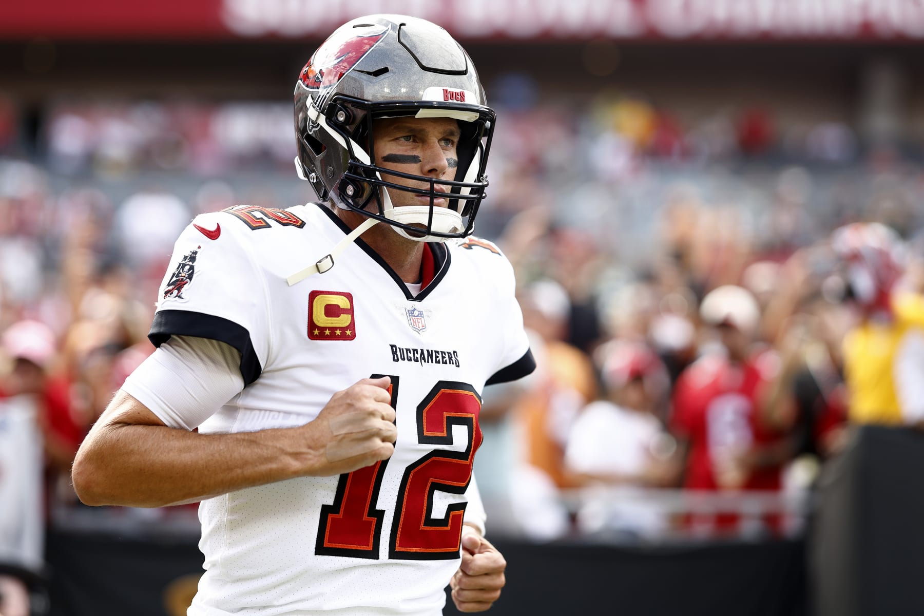 TAMPA, FLORIDA - SEPTEMBER 25: Tom Brady #12 of the Tampa Bay Buccaneers runs out to the field during warm-ups prior to the game against the Green Bay Packers at Raymond James Stadium on September 25, 2022 in Tampa, Florida. (Photo by Douglas P. DeFelice/Getty Images)