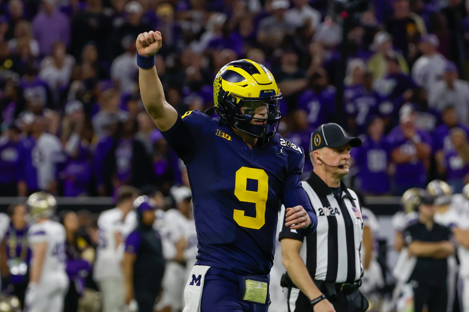 HOUSTON, TX - JANUARY 08: Michigan Wolverines quarterback J.J. McCarthy (9) holds his arm up after another Michigan touchdown during the CFP National Championship game Michigan Wolverines and Washington Huskies on January 8, 2024, at NRG Stadium in Houston, Texas. (Photo by David Buono/Icon Sportswire via Getty Images)