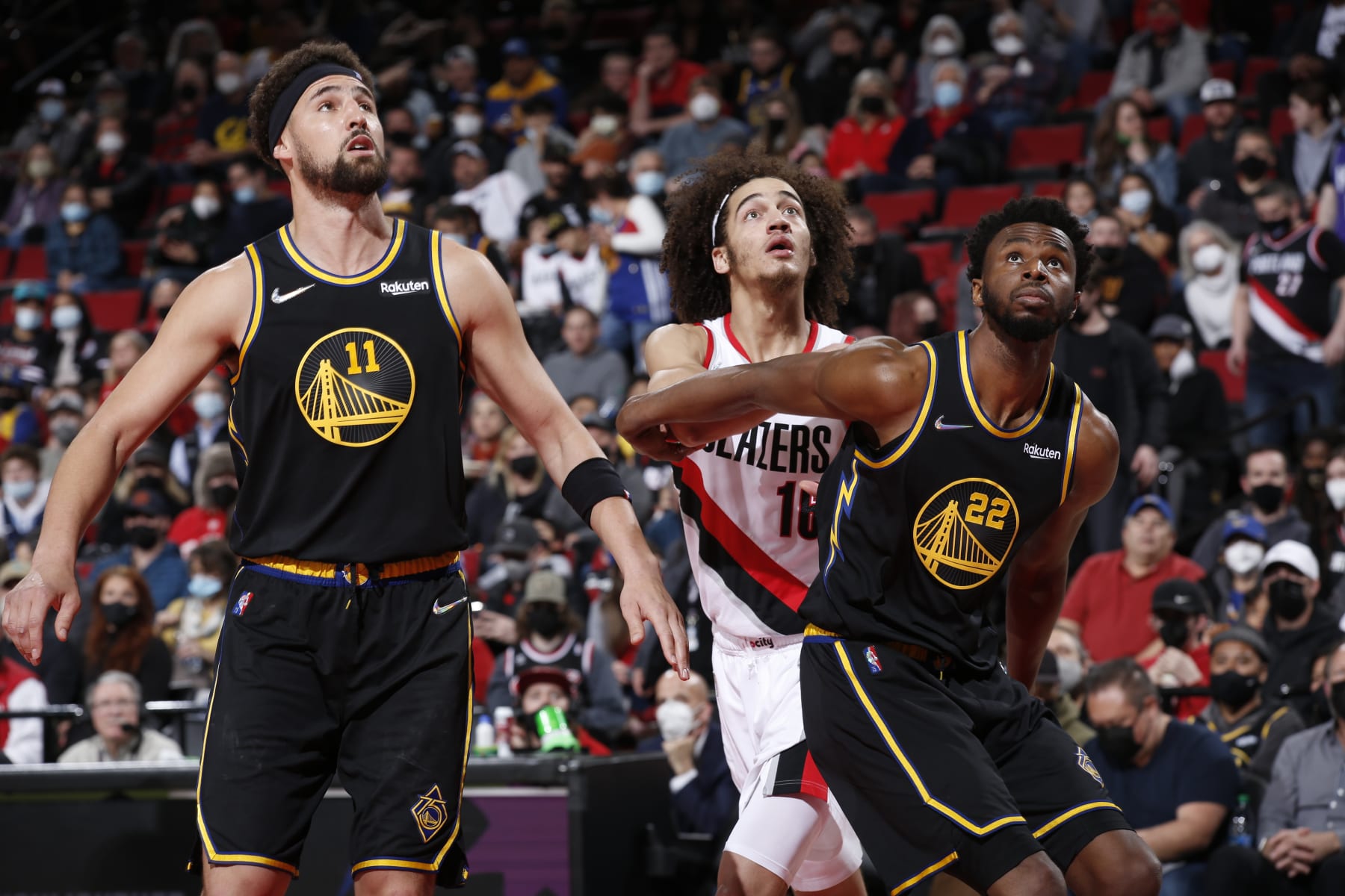 PORTLAND, OR - FEBRUARY 24: Andrew Wiggins #22 of the Golden State Warriors boxes out CJ Elleby #16 of the Portland Trail Blazers as Klay Thompson #11 of the Golden State Warriors looks on during the game on February 24, 2022 at the Moda Center Arena in Portland, Oregon. NOTE TO USER: User expressly acknowledges and agrees that, by downloading and or using this photograph, user is consenting to the terms and conditions of the Getty Images License Agreement. Mandatory Copyright Notice: Copyright 2022 NBAE (Photo by Cameron Browne/NBAE via Getty Images)