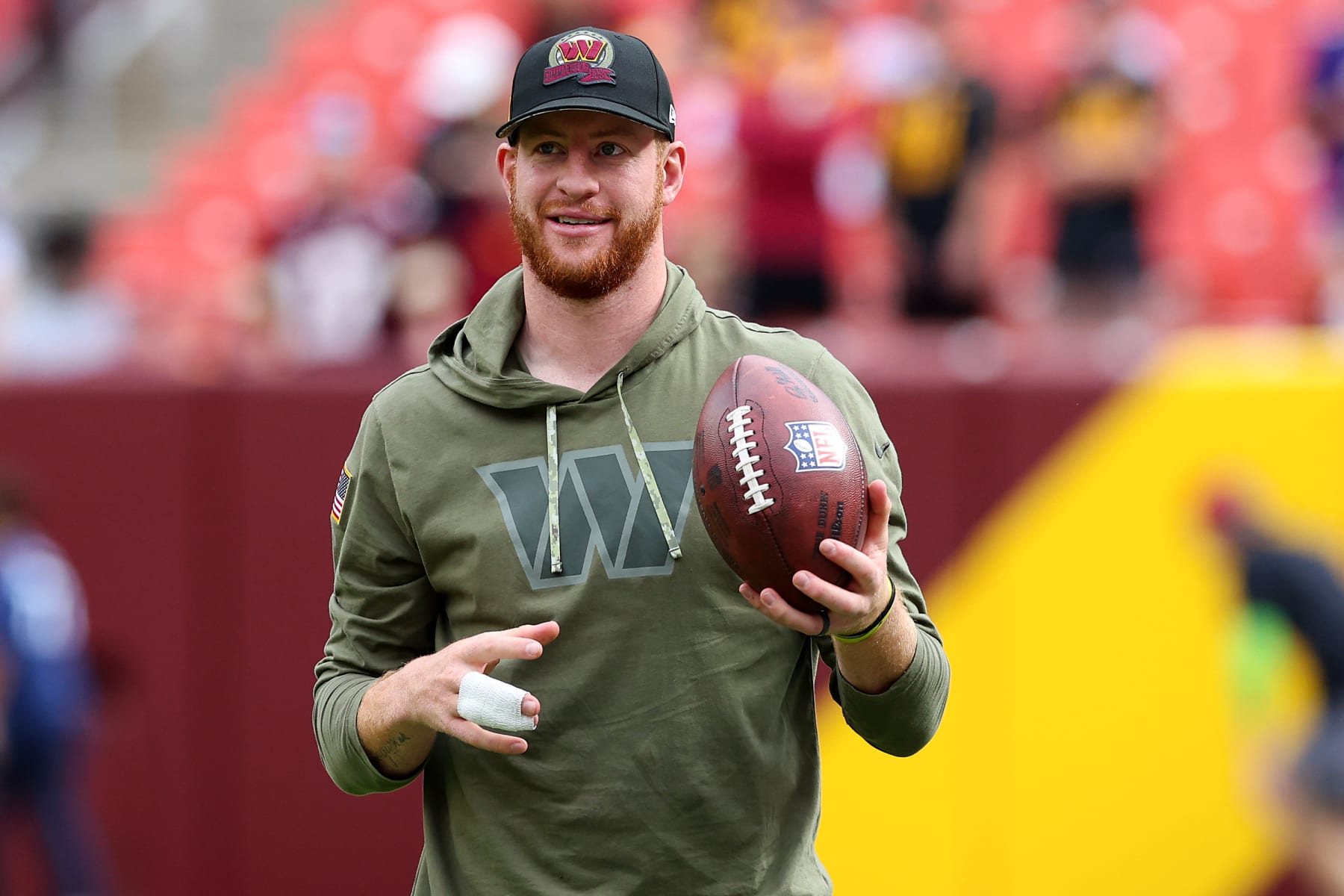 LANDOVER, MARYLAND - NOVEMBER 06: Carson Wentz #11 of the Washington Commanders stands on the field during pregame prior to the game against the Minnesota Vikings at FedExField on November 06, 2022 in Landover, Maryland. (Photo by Todd Olszewski/Getty Images)