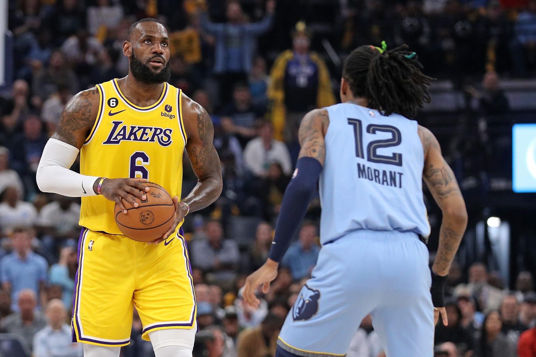 MEMPHIS, TENNESSEE - APRIL 26: LeBron James #6 of the Los Angeles Lakers handles the ball against Ja Morant #12 of the Memphis Grizzlies during Game Five of the Western Conference First Round Playoffs at FedExForum on April 26, 2023 in Memphis, Tennessee. NOTE TO USER: User expressly acknowledges and agrees that, by downloading and or using this photograph, User is consenting to the terms and conditions of the Getty Images License Agreement. (Photo by Justin Ford/Getty Images)