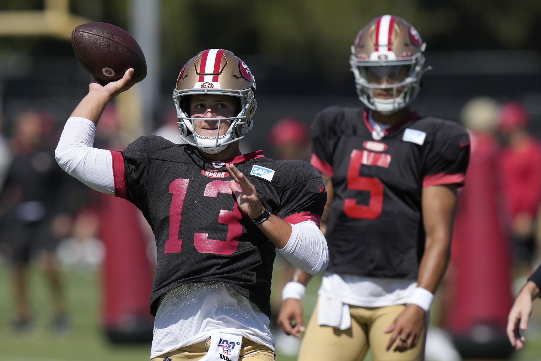 San Francisco 49ers quarterback Brock Purdy (13) throws a pass in front of Trey Lance (5) during the NFL team's football training camp in Santa Clara, Calif., Monday, July 31, 2023. (AP Photo/Jeff Chiu)