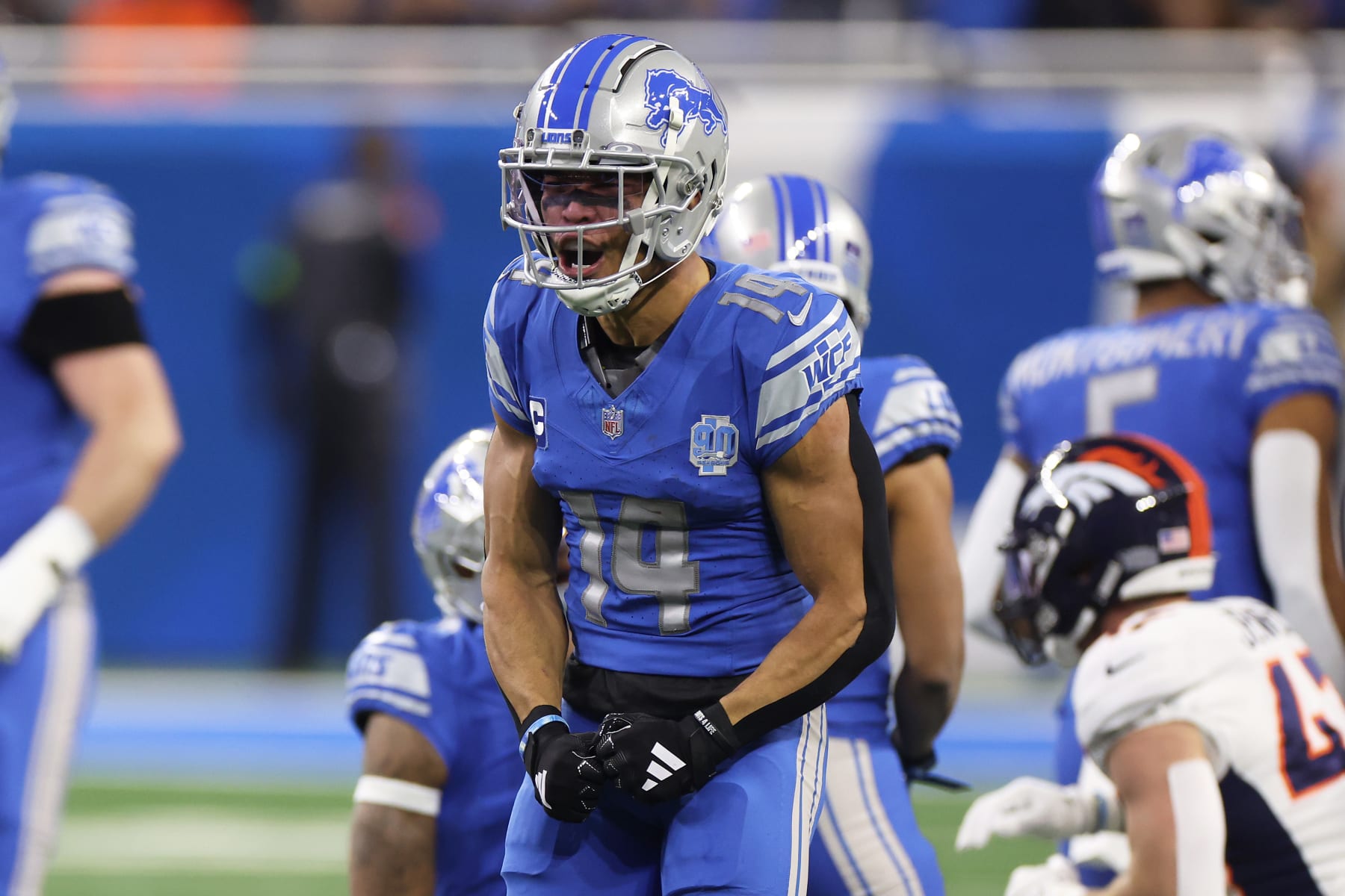 DETROIT, MICHIGAN - DECEMBER 16: Amon-Ra St. Brown #14 of the Detroit Lions reacts after a catch during the first quarter against the Denver Broncos at Ford Field on December 16, 2023 in Detroit, Michigan. (Photo by Gregory Shamus/Getty Images)