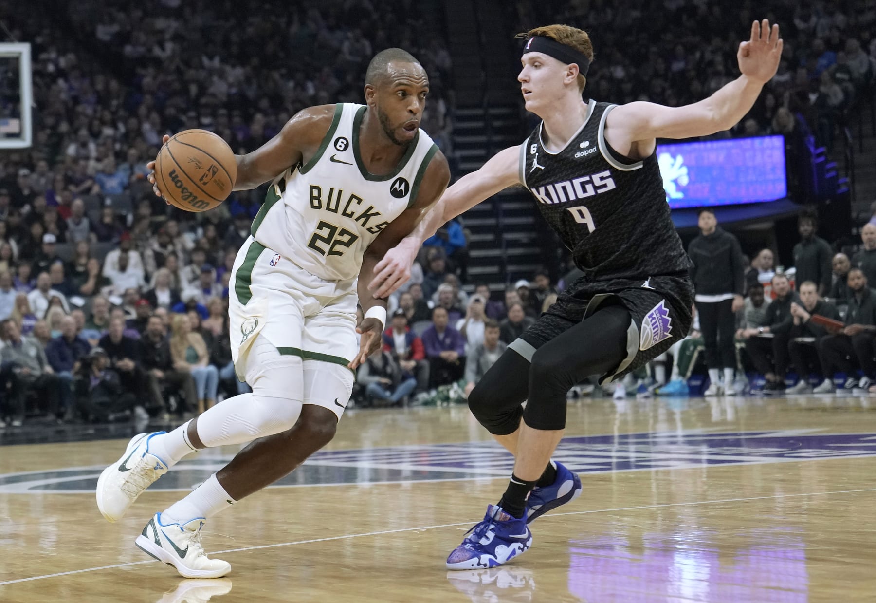 SACRAMENTO, CALIFORNIA - MARCH 13: Khris Middleton #22 of the Milwaukee Bucks dribbling the ball while defended by Kevin Huerter #9 of the Sacramento Kings during the first quarter of an NBA basketball game at Golden 1 Center on March 13, 2023 in Sacramento, California. NOTE TO USER: User expressly acknowledges and agrees that, by downloading and or using this photograph, User is consenting to the terms and conditions of the Getty Images License Agreement. (Photo by Thearon W. Henderson/Getty Images)