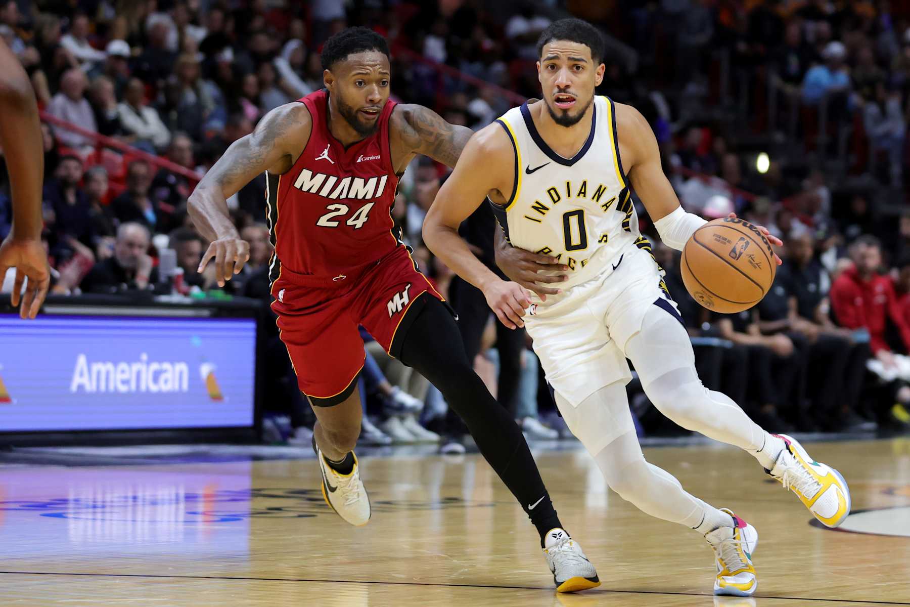 MIAMI, FLORIDA - NOVEMBER 30: Tyrese Haliburton #0 of the Indiana Pacers drives against Haywood Highsmith #24 of the Miami Heat during the third quarter of the game at Kaseya Center on November 30, 2023 in Miami, Florida. NOTE TO USER: User expressly acknowledges and agrees that, by downloading and or using this photograph, User is consenting to the terms and conditions of the Getty Images License Agreement. (Photo by Megan Briggs/Getty Images)