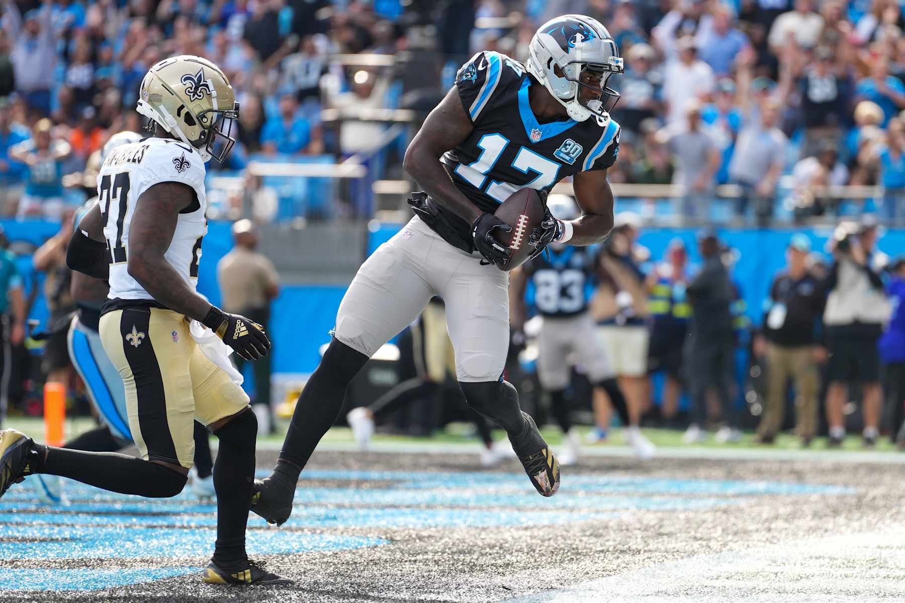 CHARLOTTE, NORTH CAROLINA - NOVEMBER 03: Xavier Legette #17 of the Carolina Panthers catches a touchdown pass while defended by Shemar Jean-Charles #27 of the New Orleans Saints during the second quarter at Bank of America Stadium on November 03, 2024 in Charlotte, North Carolina. (Photo by Grant Halverson/Getty Images)