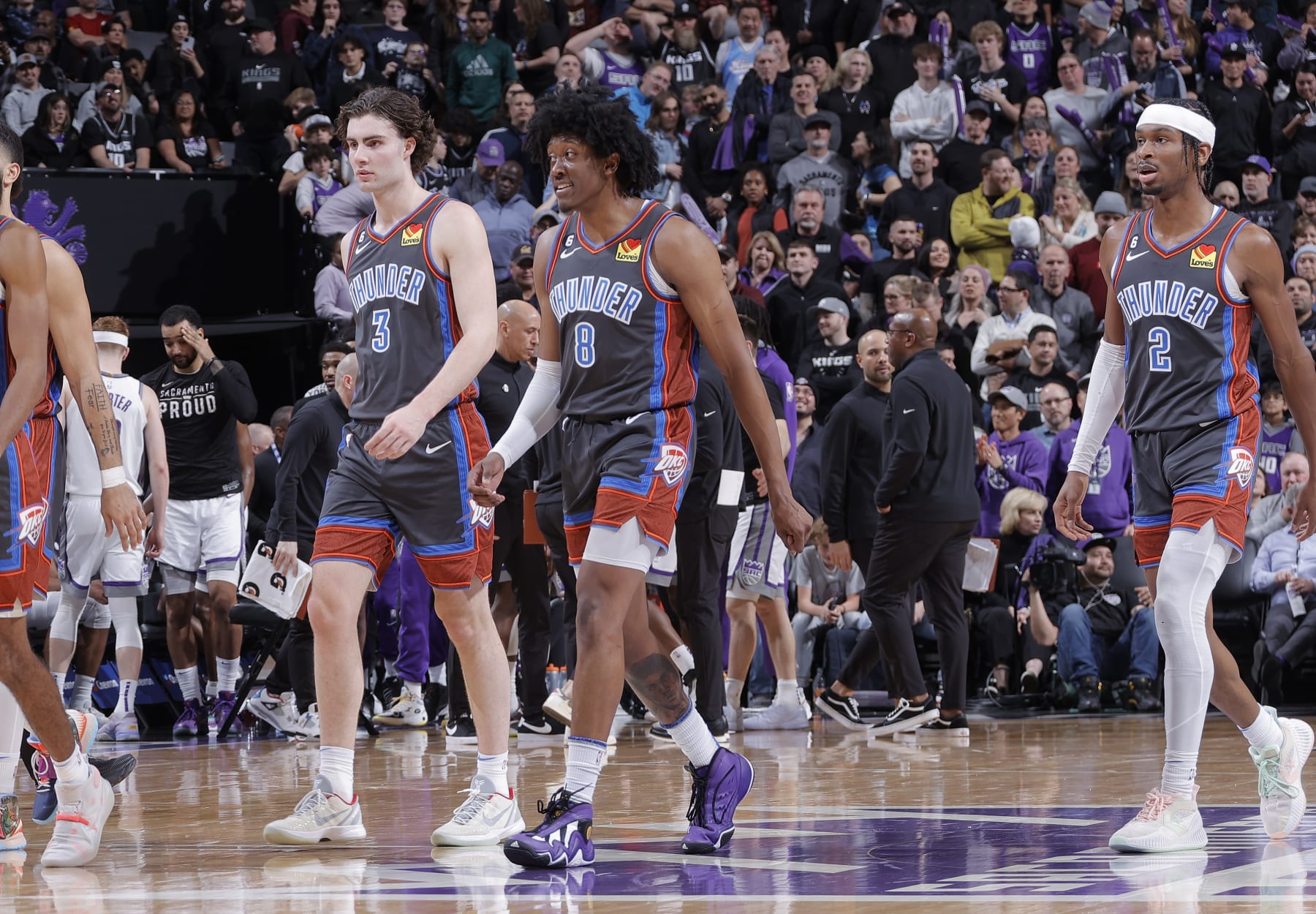 SACRAMENTO, CA - JANUARY 20: Josh Giddey #3, Jalen Williams #8, and Shai Gilgeous-Alexander #2 of the Oklahoma City Thunder walk to the bench during a timeout in a game against the Sacramento Kings on January 20, 2023 at Golden 1 Center in Sacramento, California. NOTE TO USER: User expressly acknowledges and agrees that, by downloading and or using this photograph, User is consenting to the terms and conditions of the Getty Images Agreement. Mandatory Copyright Notice: Copyright 2023 NBAE (Photo by Rocky Widner/NBAE via Getty Images)