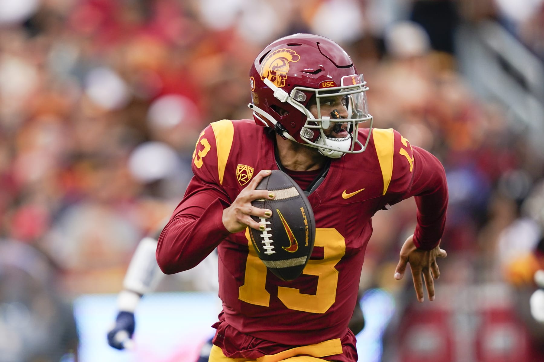 Southern California quarterback Caleb Williams (13) scrambles during the first half of an NCAA college football game against Nevada, Saturday, Sept. 2, 2023, in Los Angeles. (AP Photo/Ryan Sun)