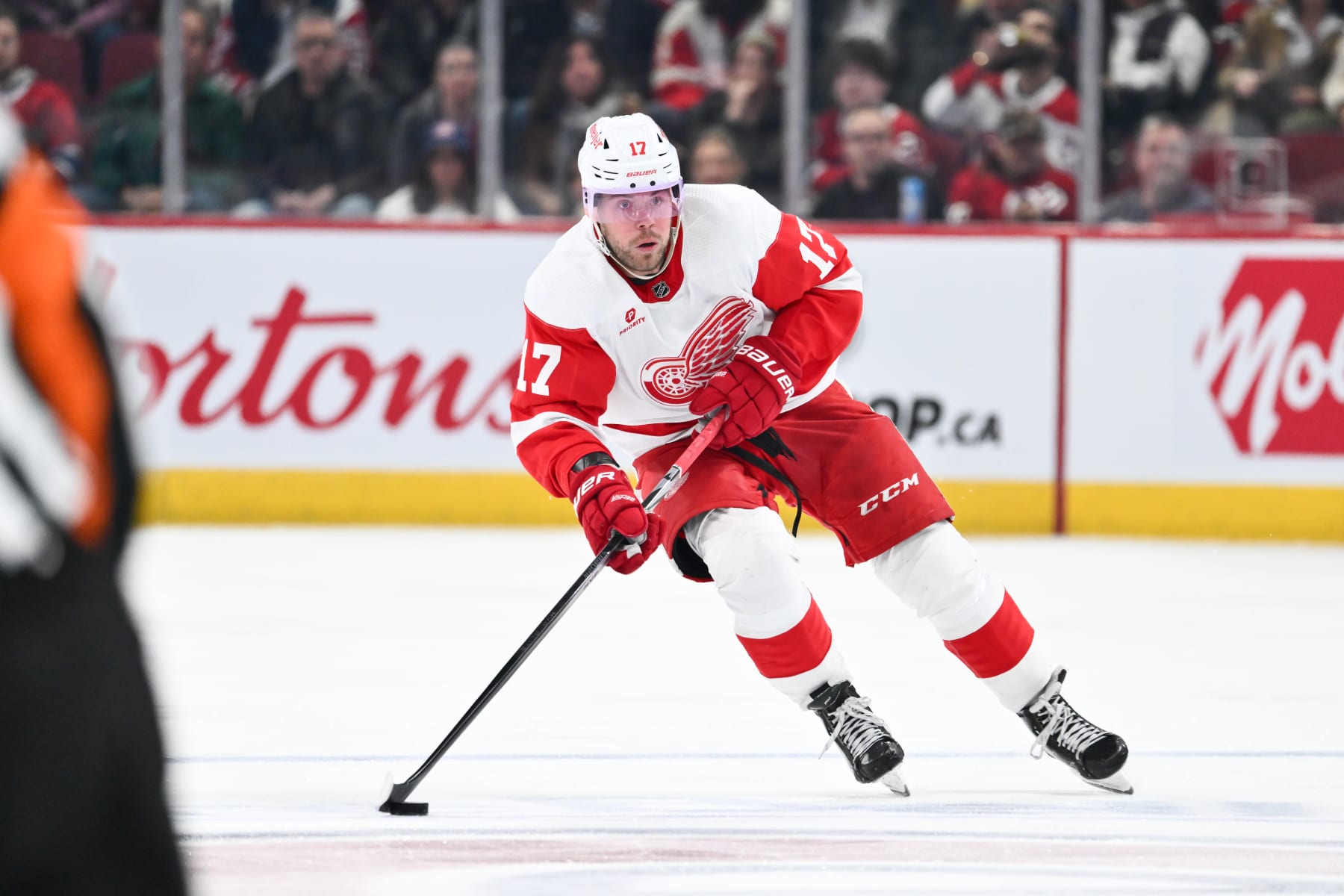 MONTREAL, CANADA - APRIL 16:  Daniel Sprong #17 of the Detroit Red Wings skates the puck during the third period against the Montreal Canadiens at the Bell Centre on April 16, 2024 in Montreal, Quebec, Canada.  The Detroit Red Wings defeated the Montreal Canadiens 5-4 in a shootout.  (Photo by Minas Panagiotakis/Getty Images)