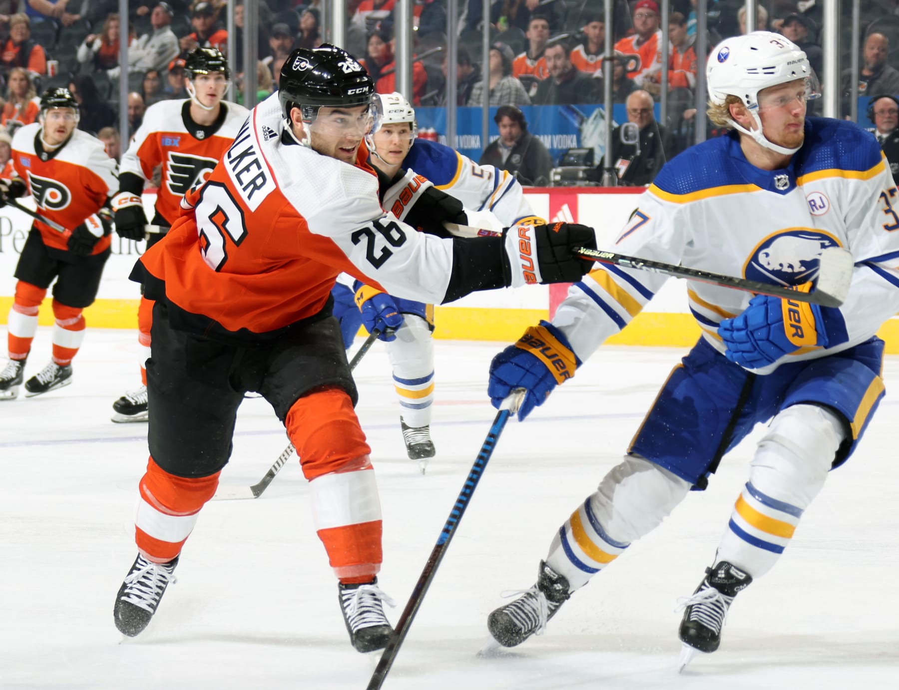 PHILADELPHIA, PENNSYLVANIA - NOVEMBER 01:  Sean Walker #26 of the Philadelphia Flyers takes a slapshot against Casey Mittelstadt #37 of the Buffalo Sabres at the Wells Fargo Center on November 1, 2023 in Philadelphia, Pennsylvania.  (Photo by Len Redkoles/NHLI via Getty Images)