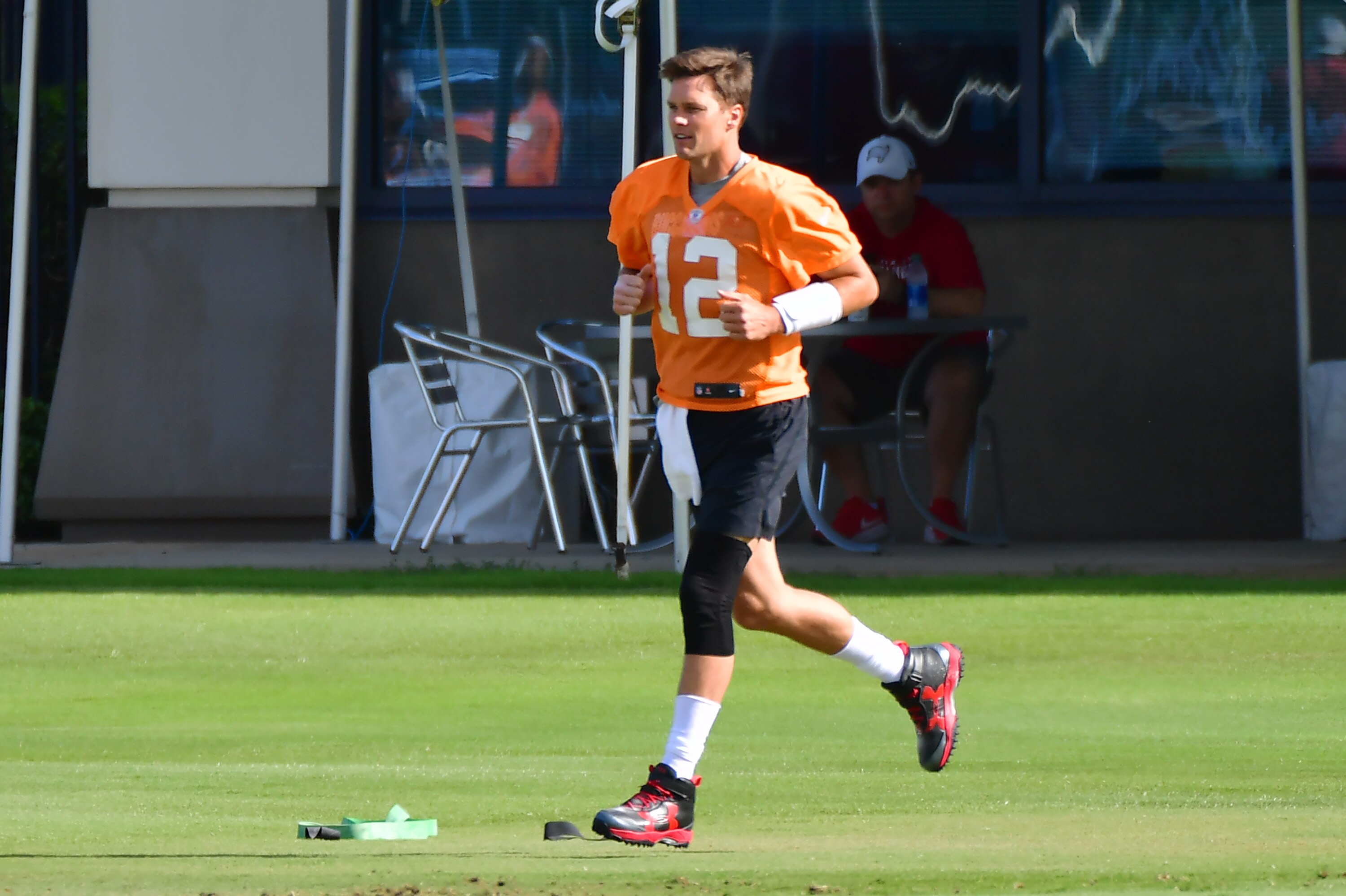 TAMPA, FLORIDA - JUNE 08: Tom Brady #12 of the Tampa Bay Buccaneers runs out to the field during the Buccaneers Mini-Camp at AdventHealth Training Center on June 08, 2021 in Tampa, Florida. (Photo by Julio Aguilar/Getty Images)