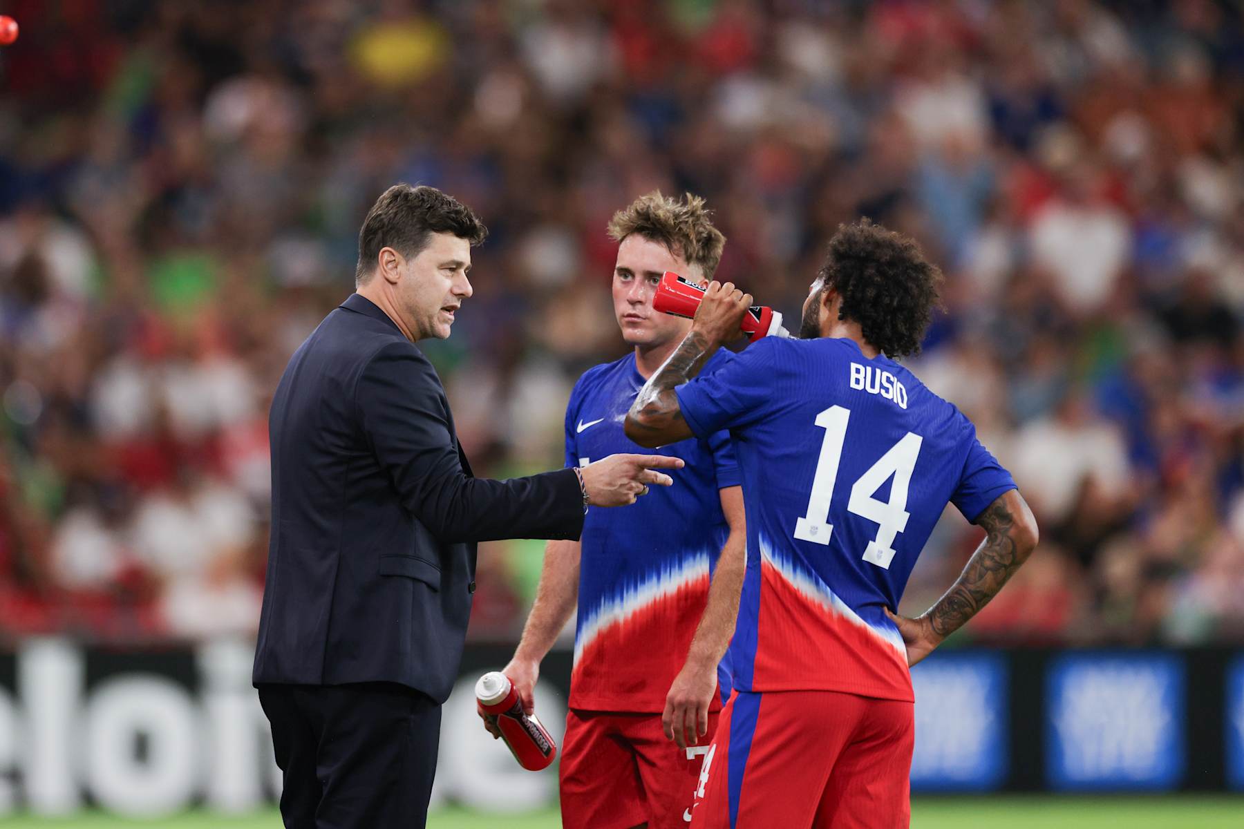AUSTIN, TEXAS - OCTOBER 12: United States head coach Mauricio Pochettino talks with Aidan Morris #7 and Gianluca Busio #14 during the second half against p at Q2 Stadium on October 12, 2024 in Austin, Texas. (Photo by John Dorton/ISI Photos/USSF/Getty Images)
