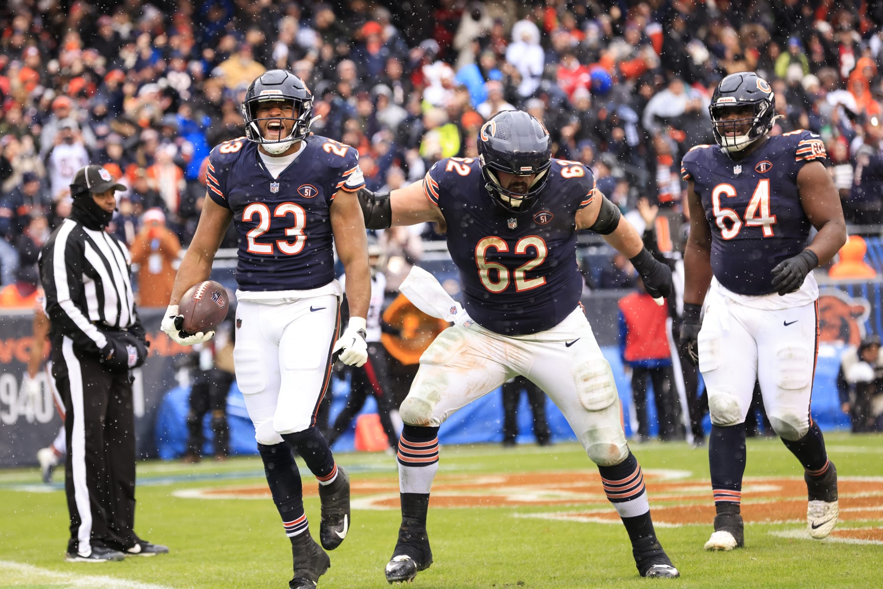 CHICAGO, ILLINOIS - DECEMBER 31: Lucas Patrick #62 of the Chicago Bears celebrates with Roschon Johnson #23 of the Chicago Bears after Johnson's rushing touchdown during the second quarter against the Atlanta Falcons at Soldier Field on December 31, 2023 in Chicago, Illinois. (Photo by Justin Casterline/Getty Images)