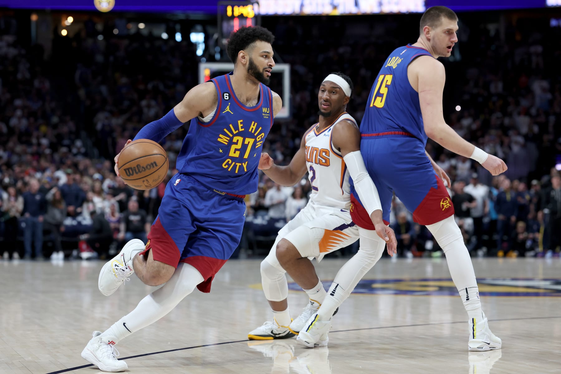 DENVER, COLORADO - APRIL 29: Jamal Murray #27 of the Denver Nuggets drives off a pick by Nikola Jokic #15 against Josh Okogie #2 of the Phoenix Suns in the first quarter at Ball Arena on April 29, 2023 in Denver, Colorado. NOTE TO USER: User expressly acknowledges and agrees that, by downloading and/or using this photograph, User is consenting to the terms and conditions of the Getty Images License Agreement. (Photo by Matthew Stockman/Getty Images)
