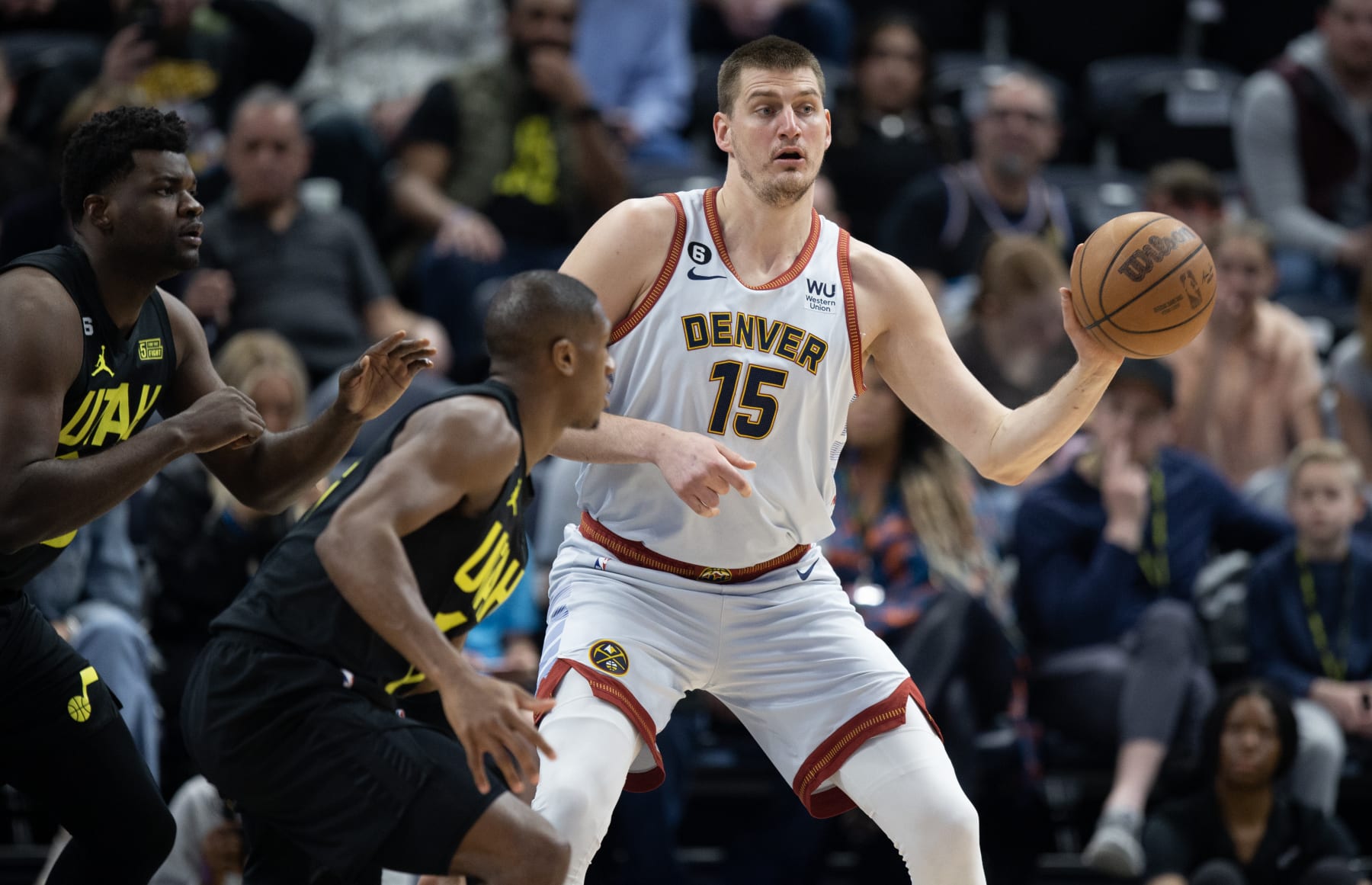 SALT LAKE CITY UT- APRIL 8: Nikola Jokic #15 of the Denver Nuggets passes around Kris Dunn #11 and Udoka Azubuike #20 of the Utah Jazz during the first half of their game April 8, 2023 at the Vivint Arena in Salt Lake City, Utah. NOTE TO USER: User expressly acknowledges and agrees that, by downloading and using this photograph, User is consenting to the terms and conditions of the Getty Images License Agreement(Photo by Chris Gardner/ Getty Images)