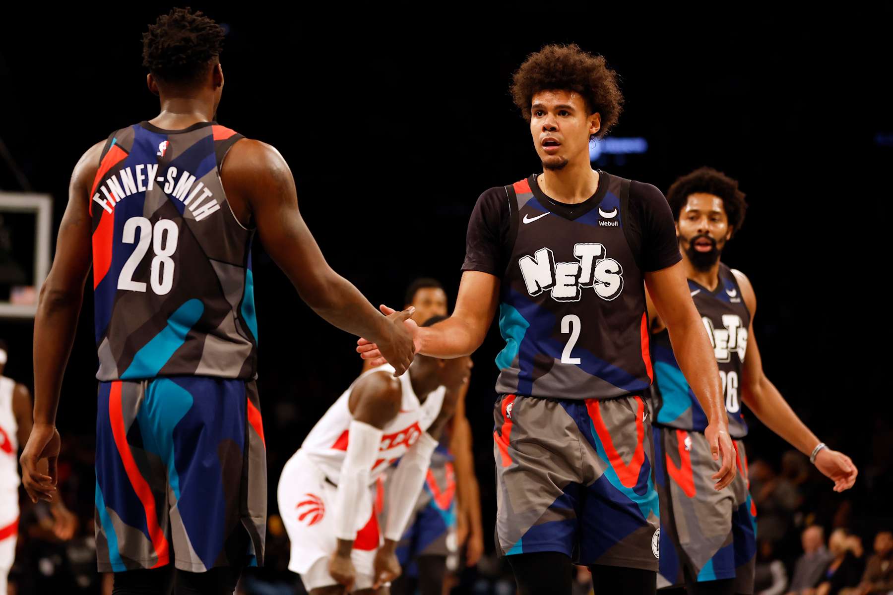 NEW YORK, NEW YORK - NOVEMBER 28: Cameron Johnson #2 high-fives Dorian Finney-Smith #28 of the Brooklyn Nets during the second half of an NBA In-Season Tournament game against the Toronto Raptors at Barclays Center on November 28, 2023 in the Brooklyn borough of New York City. The Nets won 115-103. NOTE TO USER: User expressly acknowledges and agrees that, by downloading and/or using this photograph, User is consenting to the terms and conditions of the Getty Images License Agreement. (Photo by Sarah Stier/Getty Images)