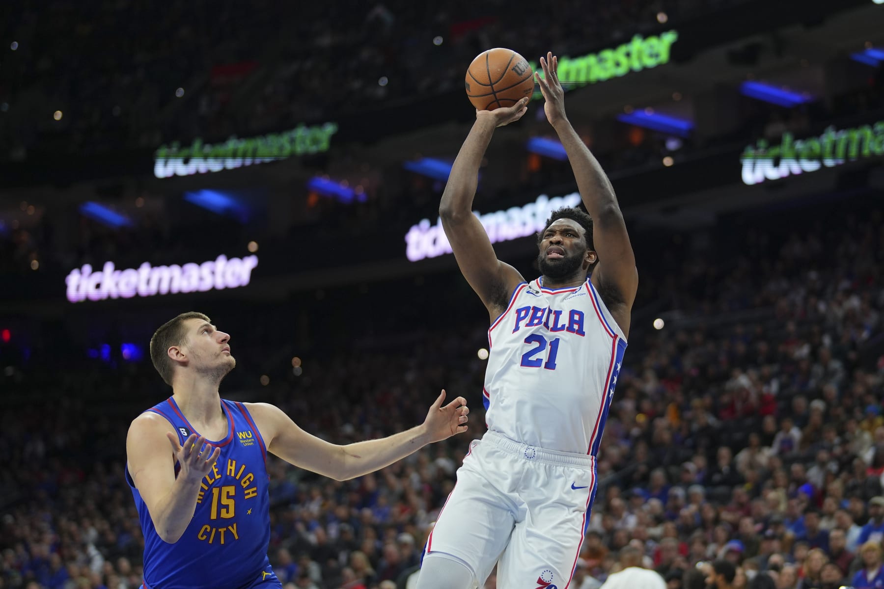 PHILADELPHIA, PA - JANUARY 28: Joel Embiid #21 of the Philadelphia 76ers shoots the ball against Nikola Jokic #15 of the Denver Nuggets in the first quarter of the game at the Wells Fargo Center on January 28, 2023 in Philadelphia, Pennsylvania.  NOTE TO USER: User expressly acknowledges and agrees that, by downloading and or using this photograph, User is consenting to the terms and conditions of the Getty Images License Agreement. (Photo by Mitchell Leff/Getty Images)