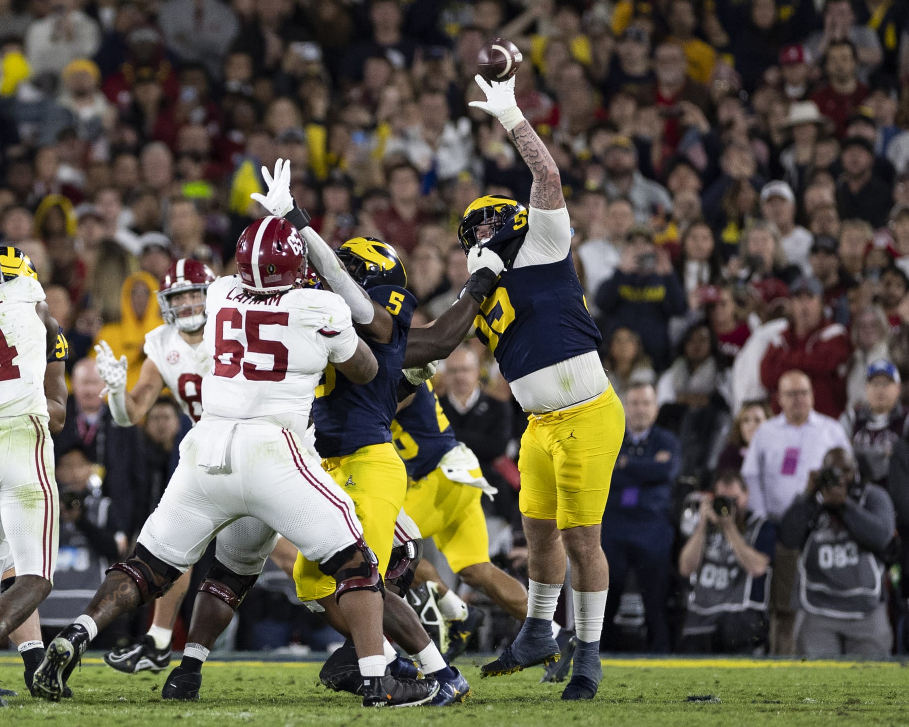 PASADENA, CA - JANUARY 1: Mason Graham #55 of the Michigan Wolverines deflects a pass from Jalen Milroe #4 of the Alabama Crimson Tide during the Rose Bowl between University of Alabama and University of Michigan at the Rose Bowl on January 1, 2024 in Pasadena, California. (Photo by Steve Limentani/ISI Photos/Getty Images)