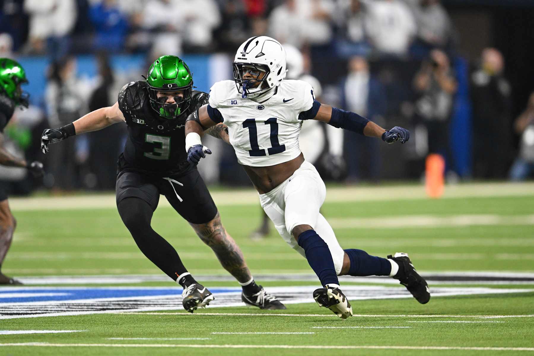 INDIANAPOLIS, IN - DECEMBER 07: Penn State Nittany Lions DE Abdul Carter (11) pressures the quarterback during a college football game between the Penn State Nittany Lions and Oregon Ducks on December 7, 2024 at Lucas Oil Stadium in Indianapolis, IN (Photo by James Black/Icon Sportswire via Getty Images)