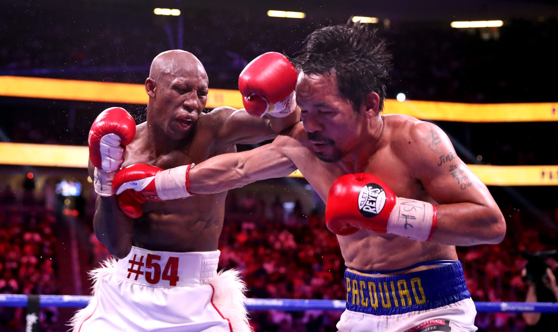 LAS VEGAS, NEVADA - AUGUST 21:  Yordenis Ugas (L) punches Manny Pacquiao during their WBA welterweight title fight at T-Mobile Arena on August 21, 2021 in Las Vegas, Nevada. Ugas retained his title by unanimous decision.   (Photo by Steve Marcus/Getty Images)